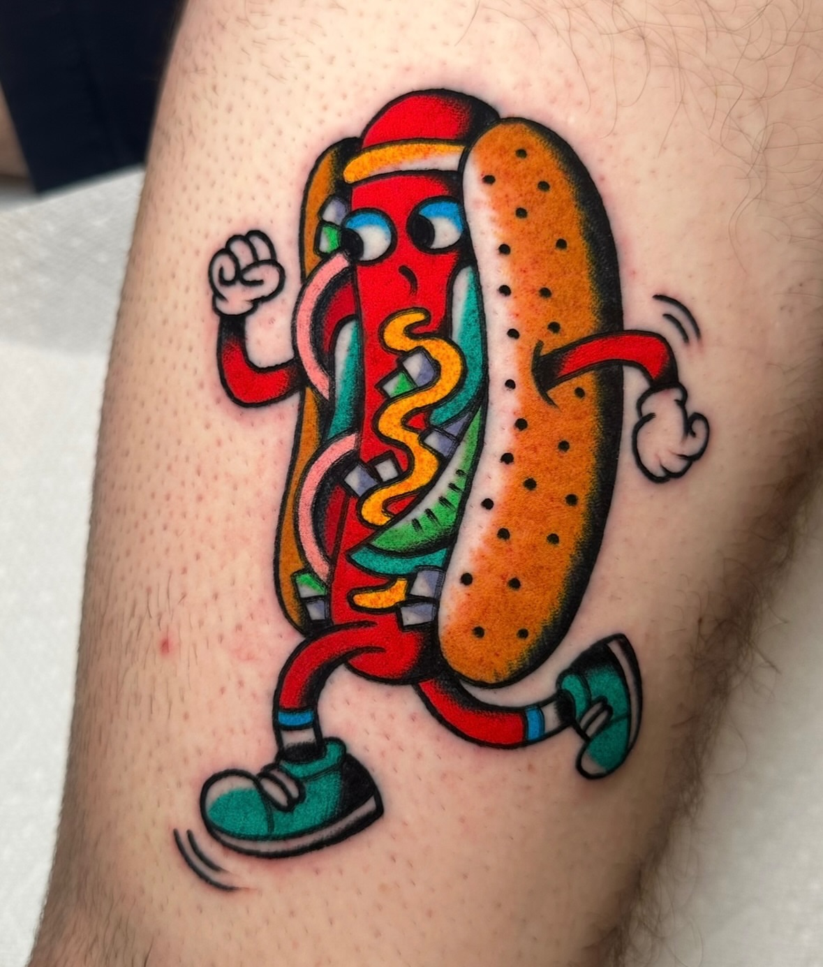 Hot dog new school tattoo on the thigh by Zahra Niedermann