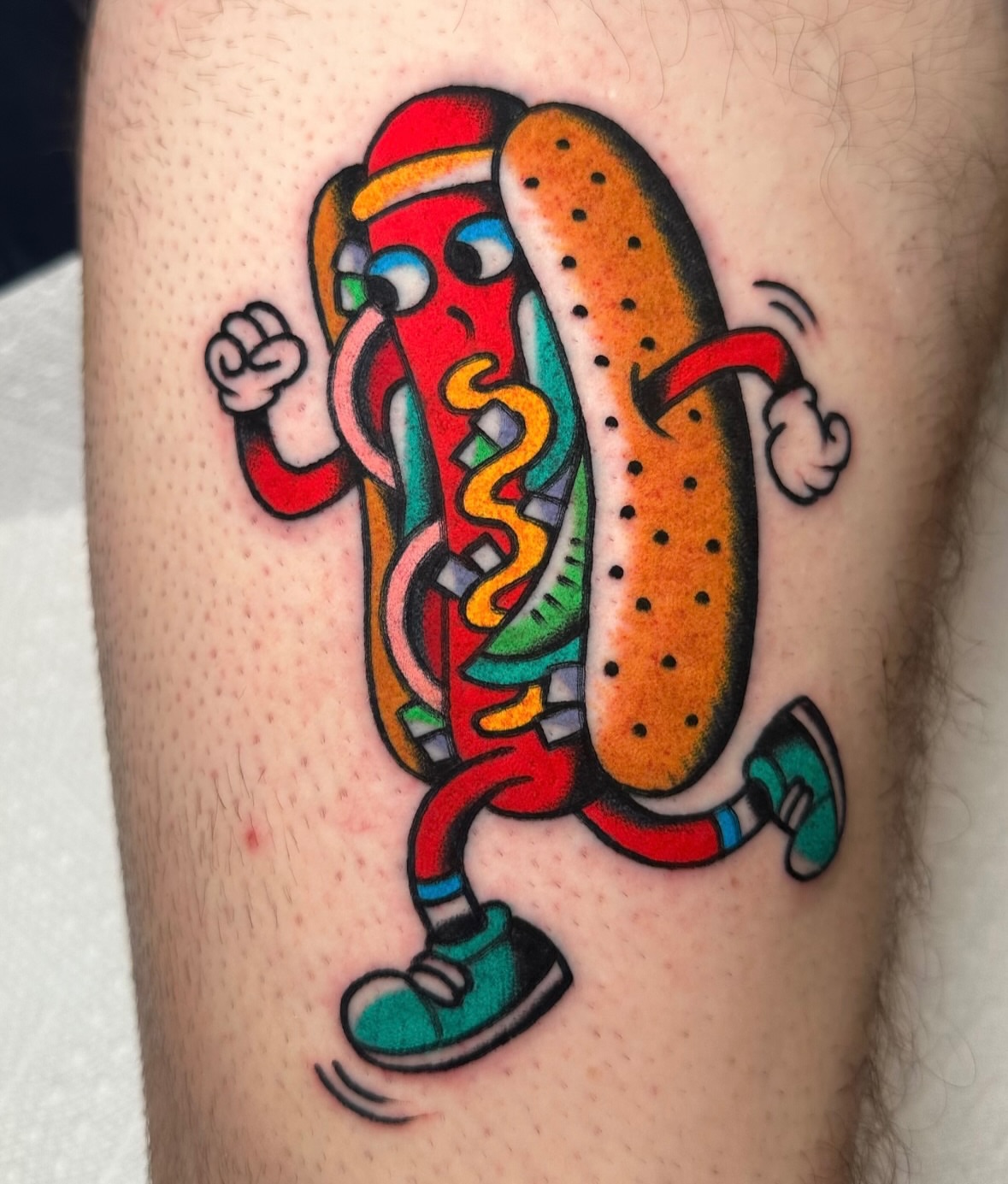 Hot dog American traditional tattoo on the forearm by Zahra Niedermann