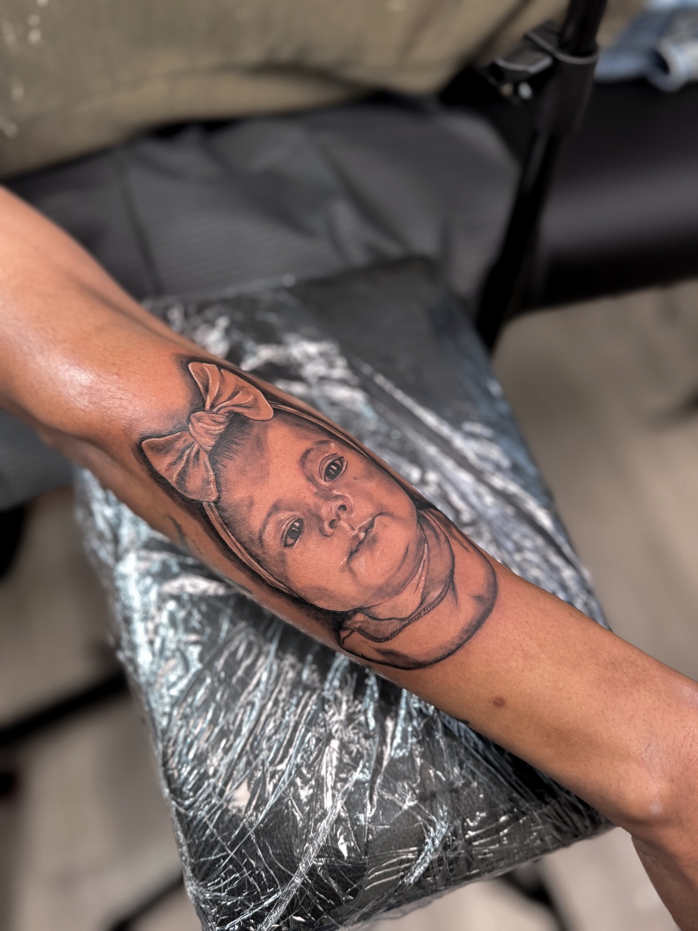 Portrait realism tattoo on the forearm by Tatuajes Denver