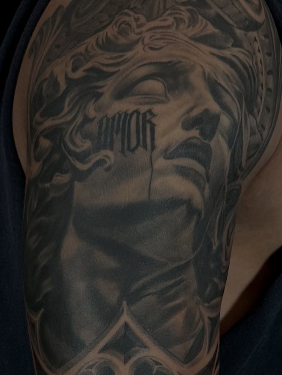 Statue black and grey tattoo on the forearm by Matthew Doherty