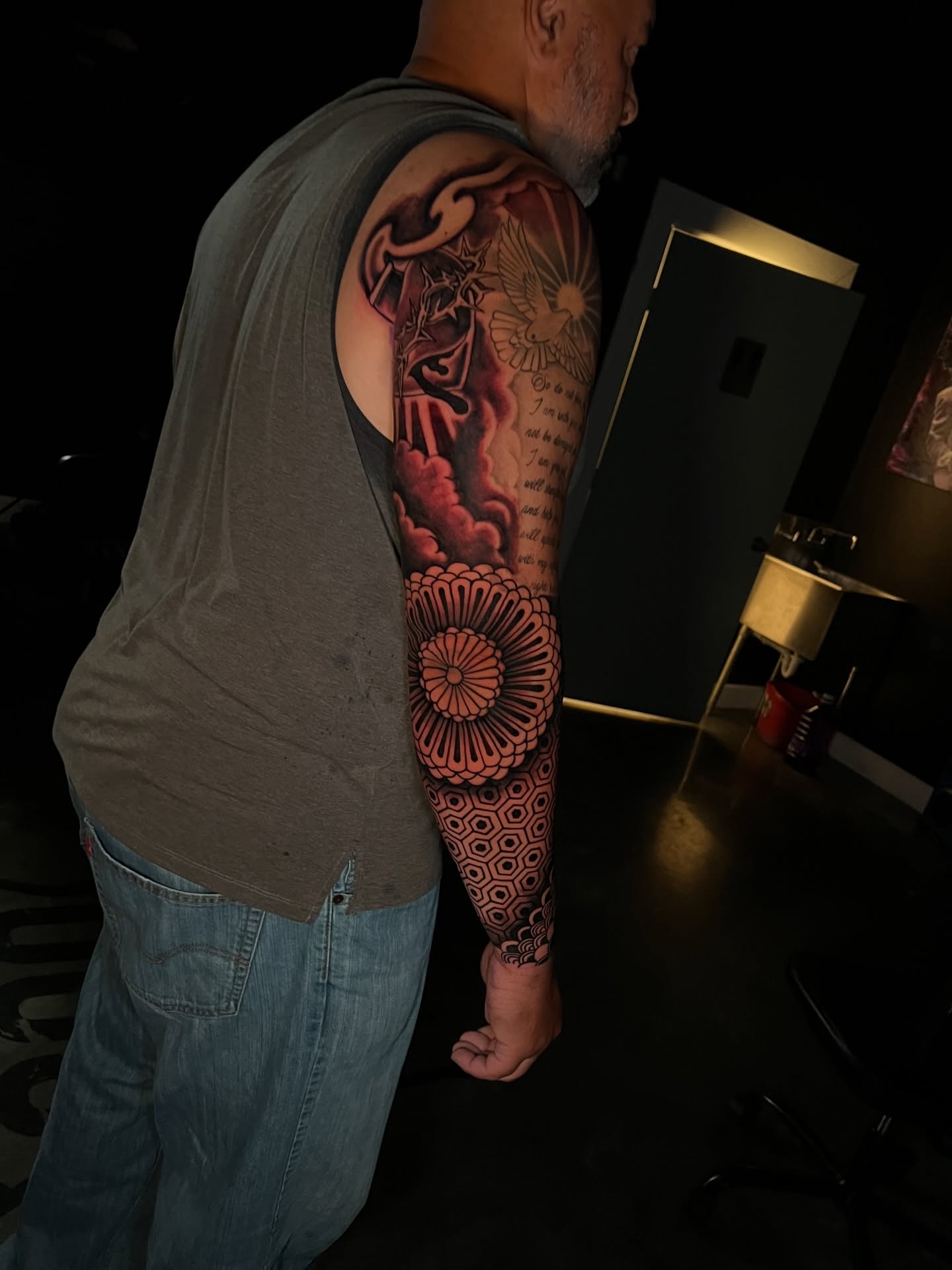 Floral mandala geometric tattoo on the upper arm by Dee