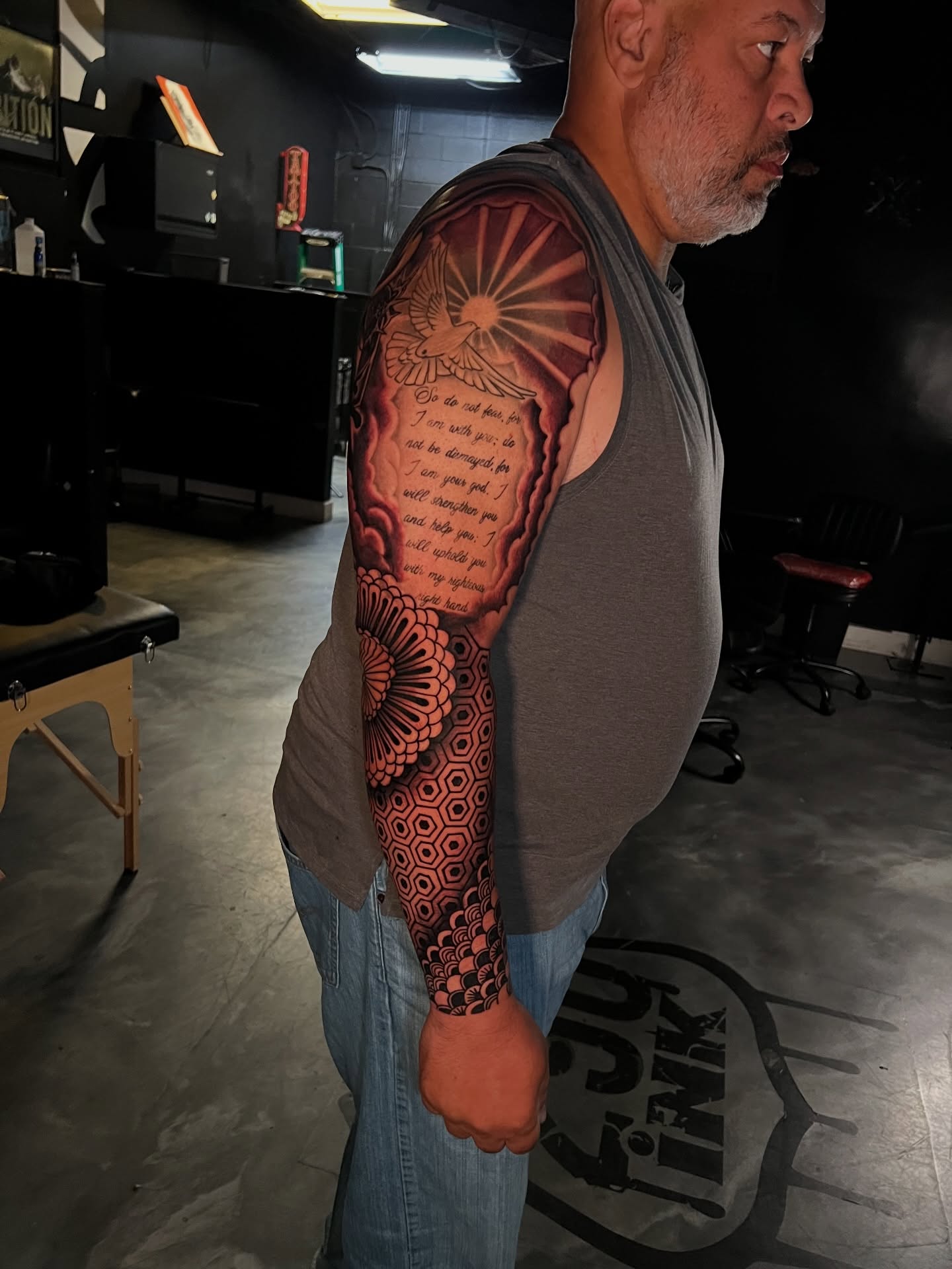 Religious verse with mandala geometric tattoo on the forearm by Dee