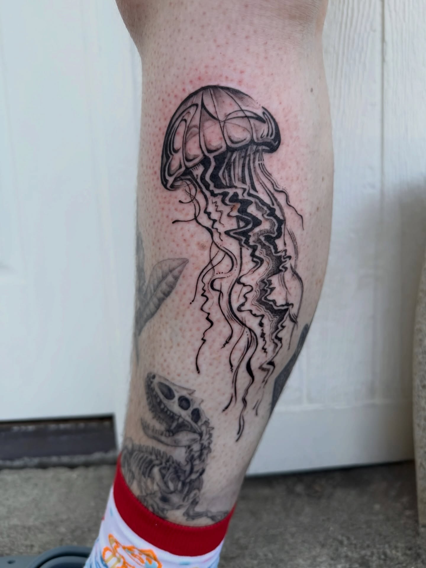 Jellyfish black and grey tattoo on the forearm by Kingtide Ink