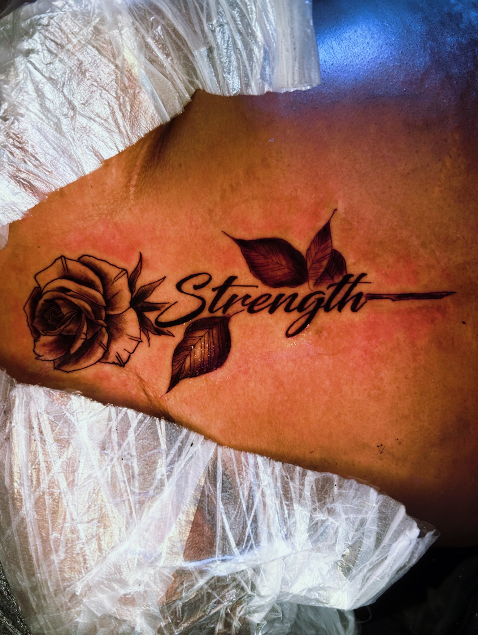Strength black and grey tattoo on the forearm by Tito Cross ❤️‍🔥