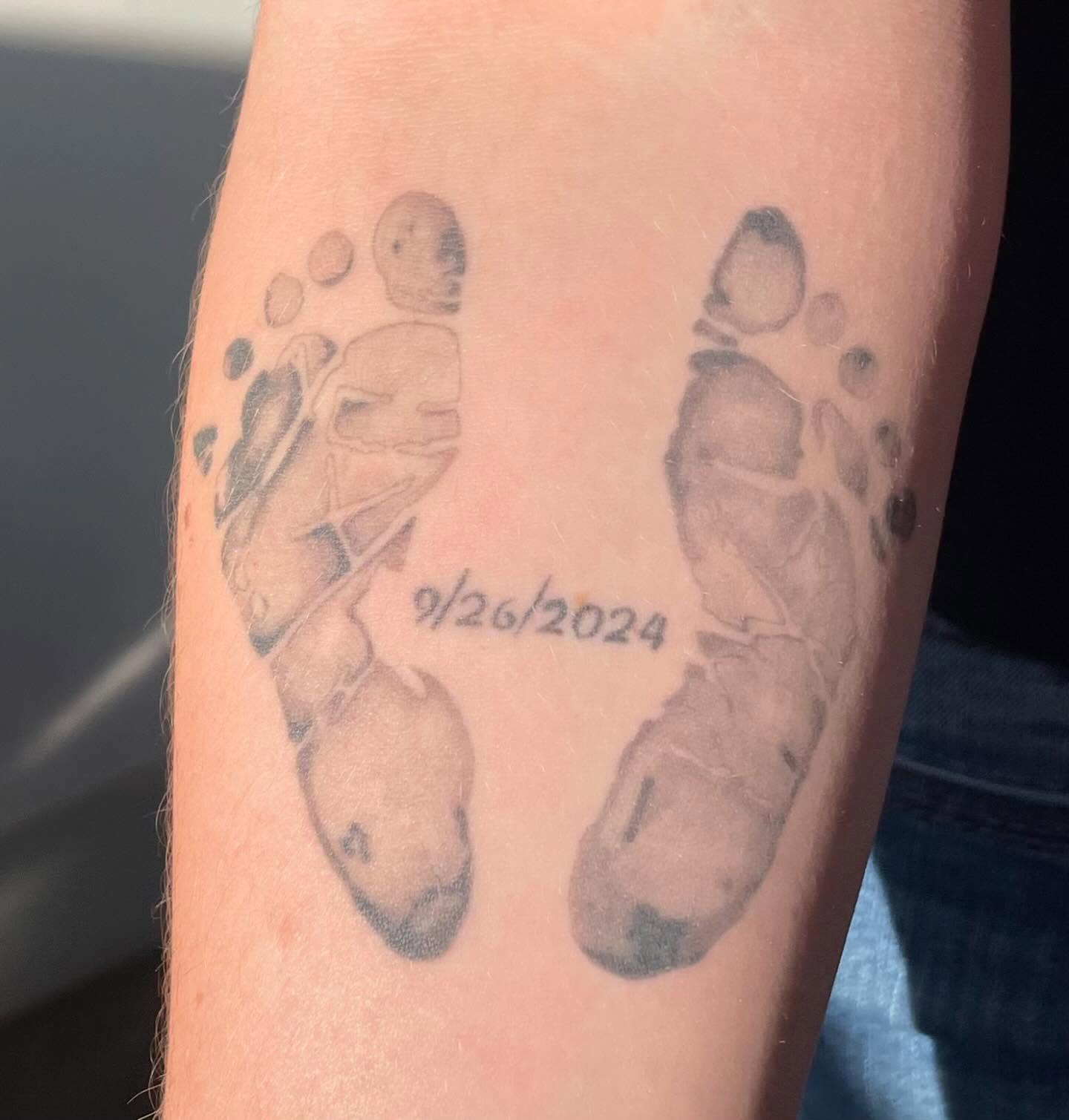 Footprints dotwork tattoo on the forearm by Avalon Sable