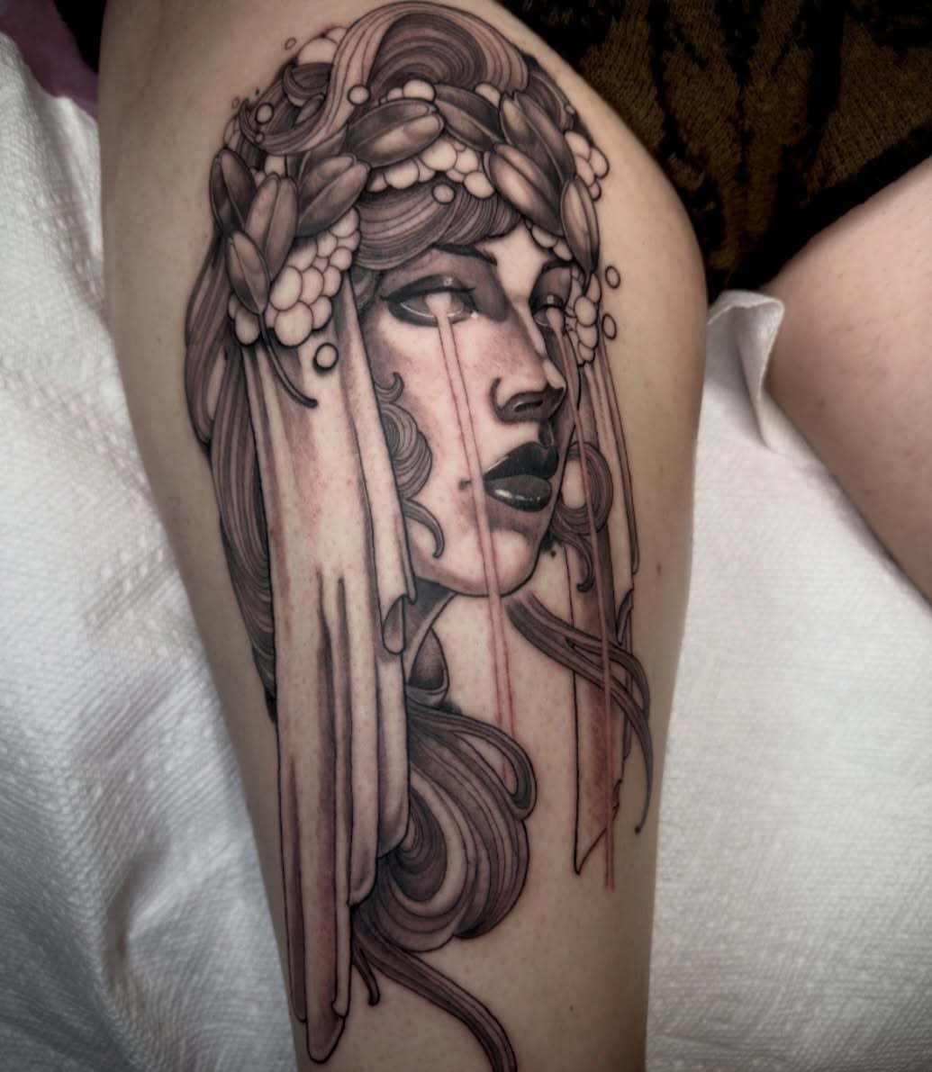Woman with floral crown realism tattoo on the forearm by Jenn Golgan