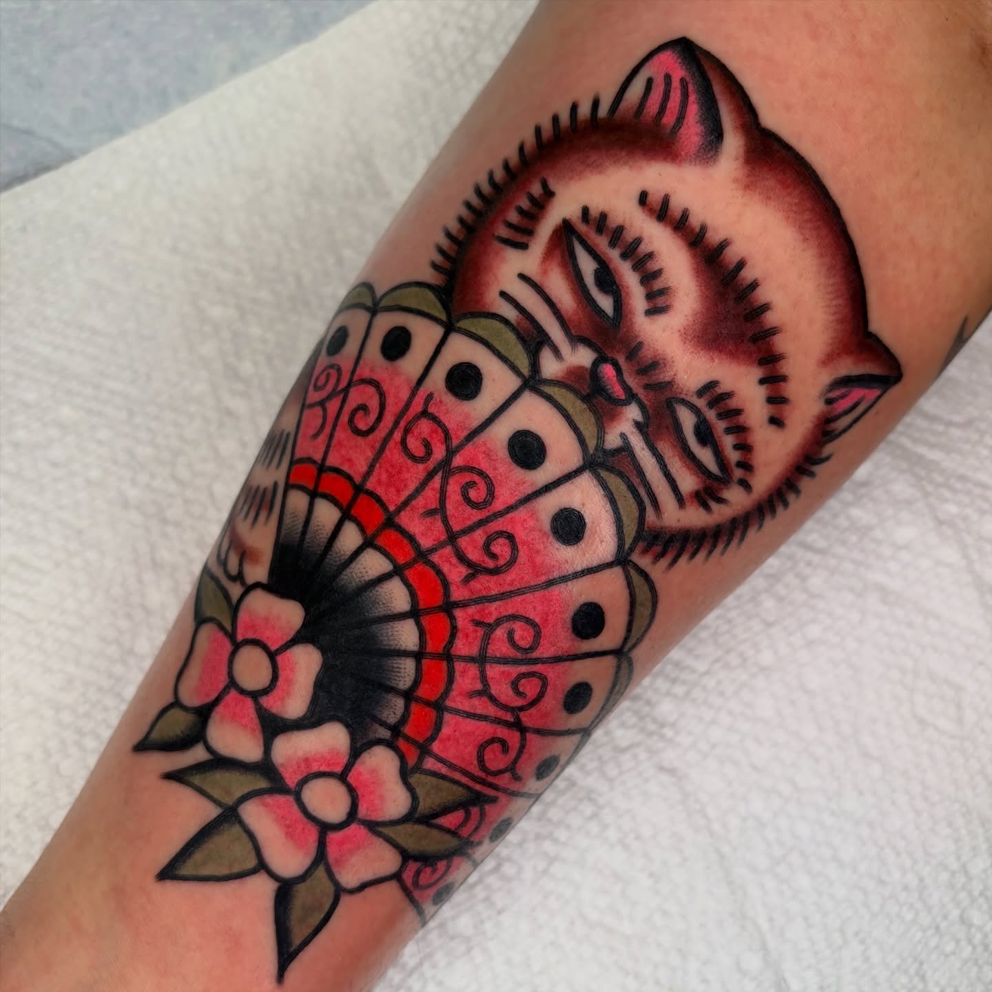 Cat and butterfly American traditional tattoo on the forearm by rachael