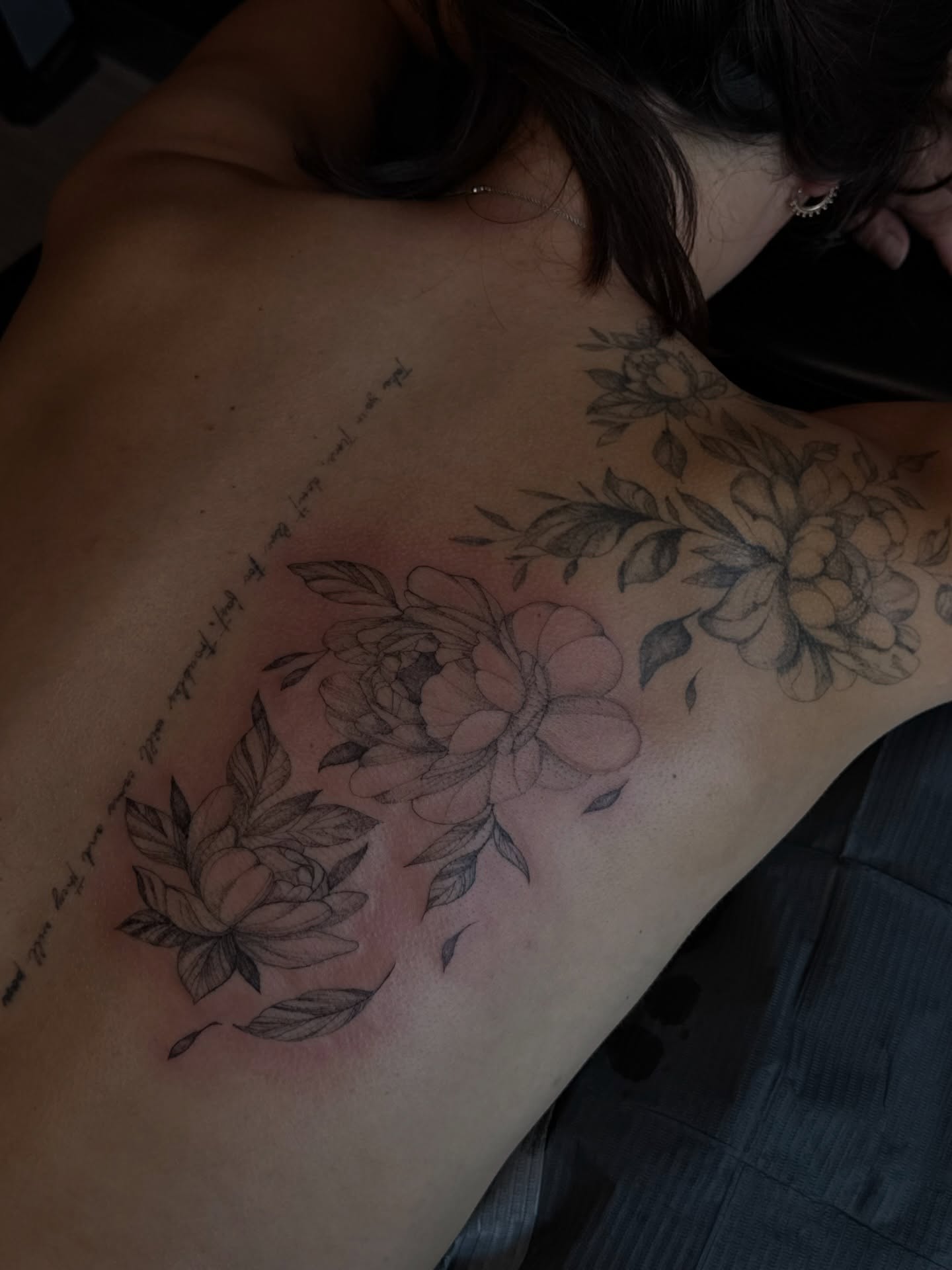 Floral arrangement black and grey tattoo on the back by Ryleigh Benjamin
