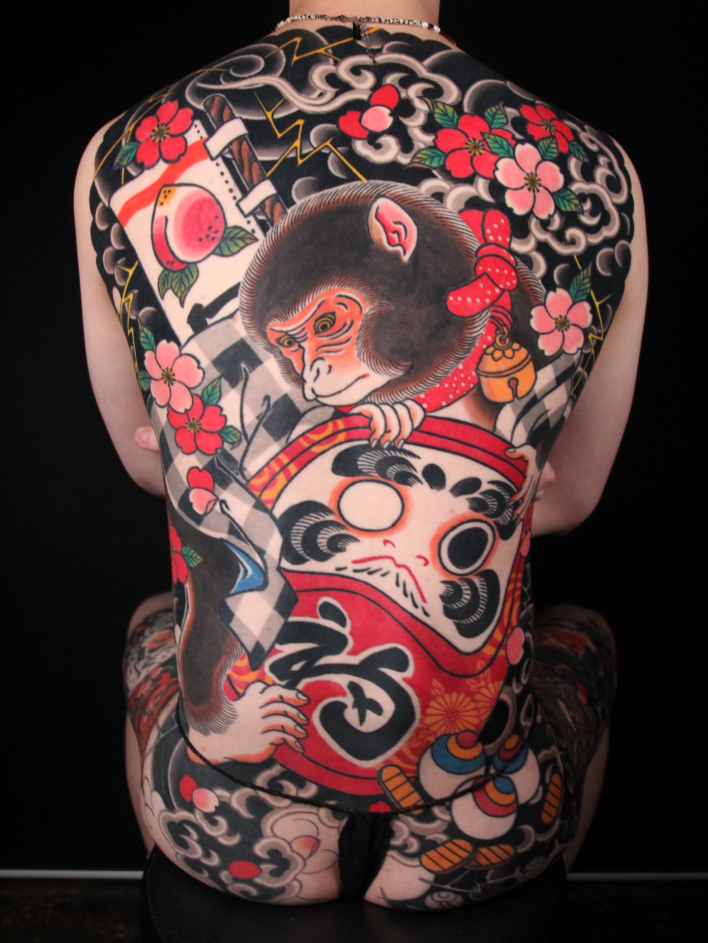 Monkey and Daruma doll japanese irezumi tattoo on the back by 건대이레즈미