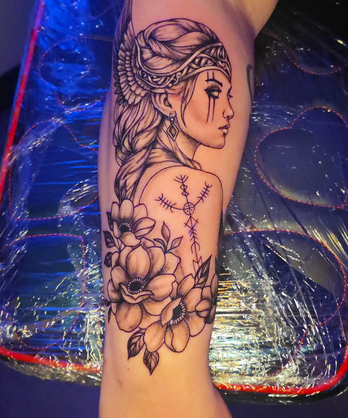 Woman with flowers realism tattoo on the forearm by Karley Michelle Moody