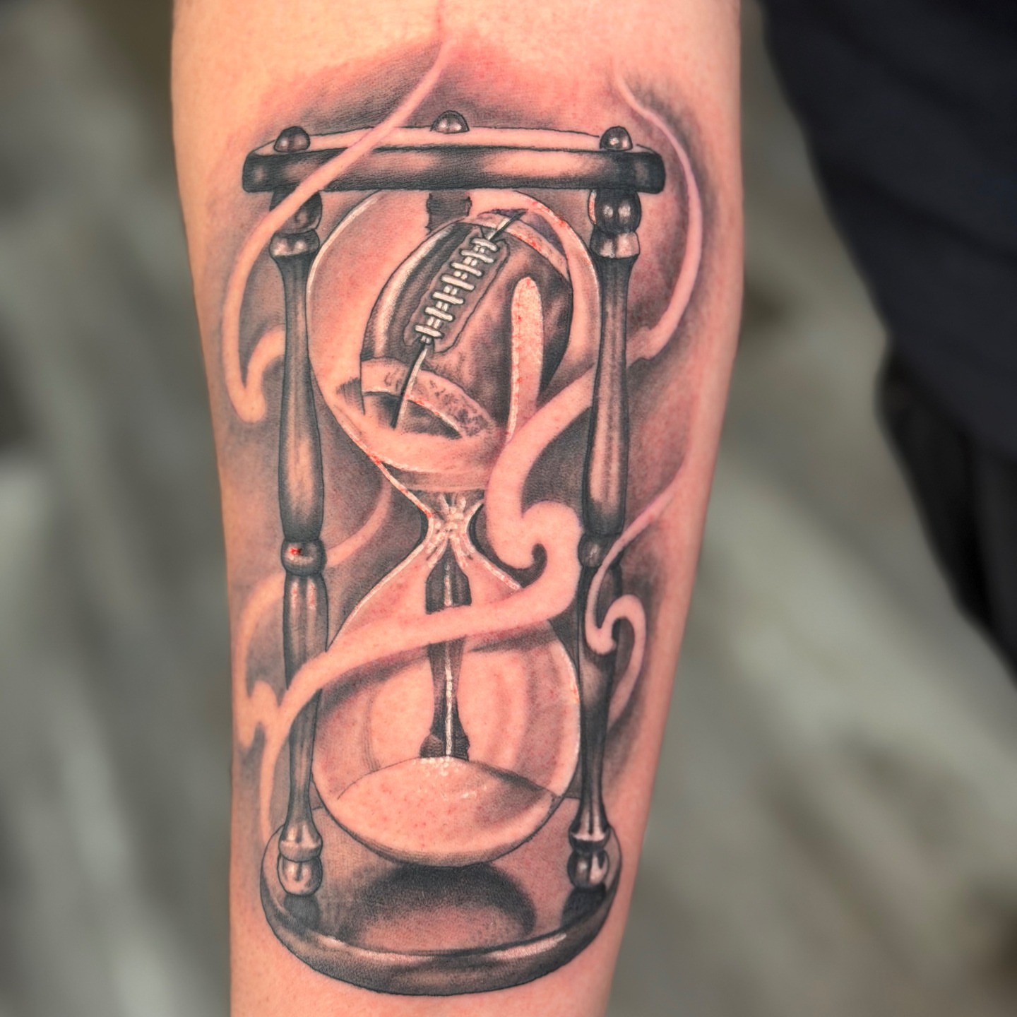 Hourglass realism tattoo on the forearm by Skoty Fox