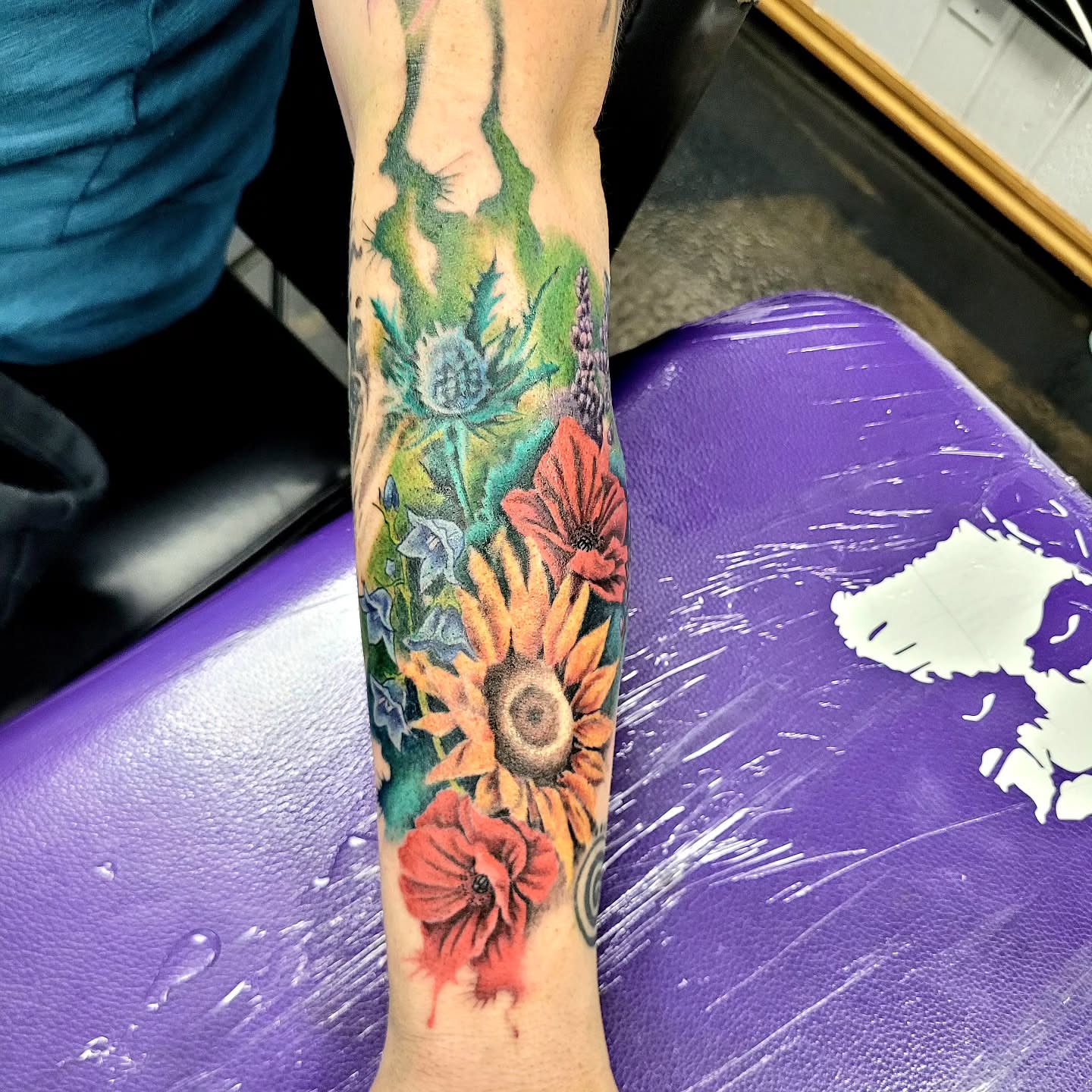 Floral bouquet realism tattoo on the forearm by Jentrey McCausland