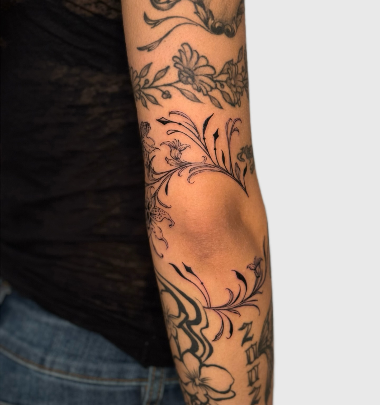 Floral design black and grey tattoo on the forearm by Miami Tattoo Artist, Miami, Florida
