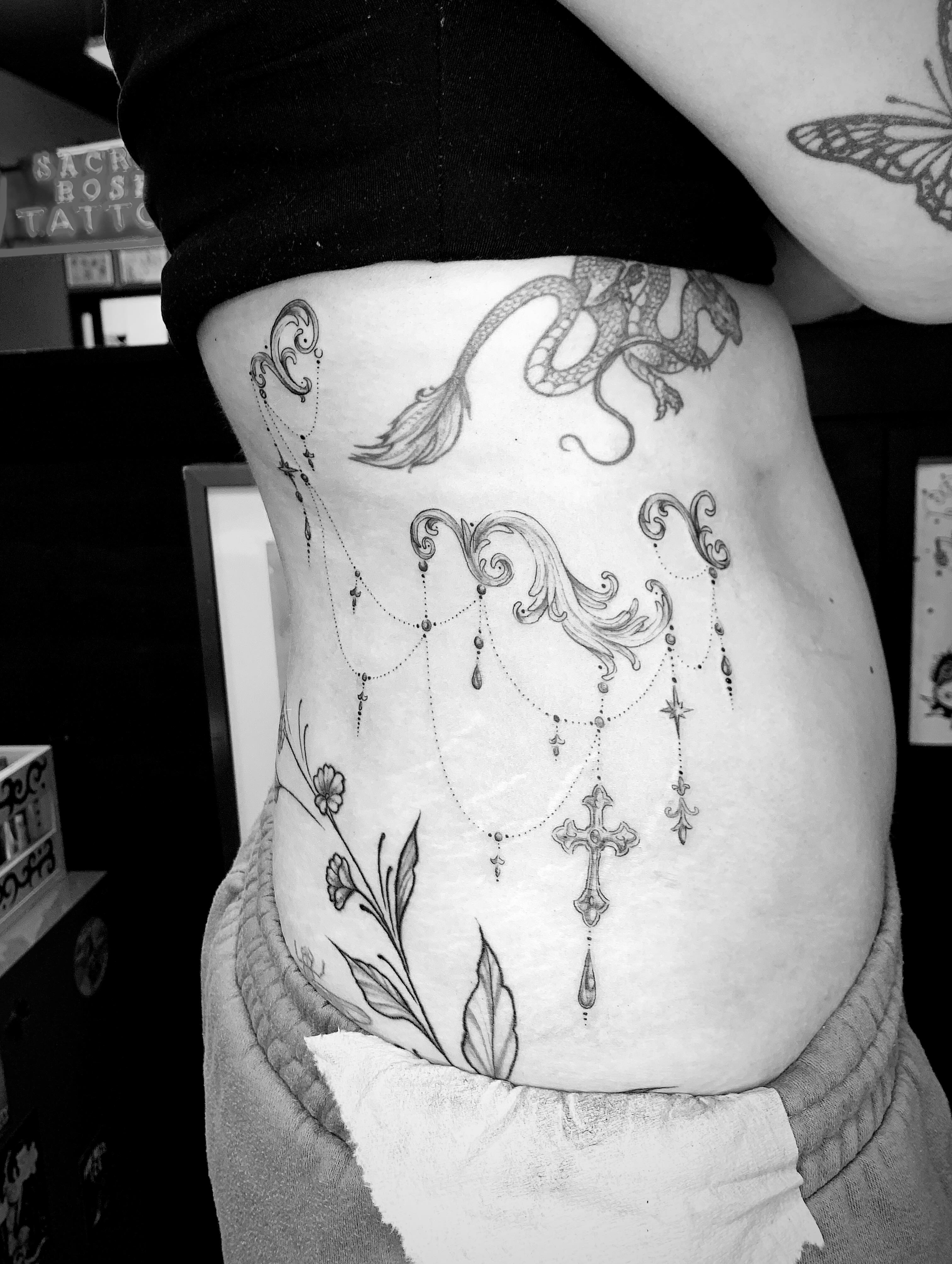 Cross and chandelier black and grey tattoo on the torso by Kitty Jones, Berkeley, California
