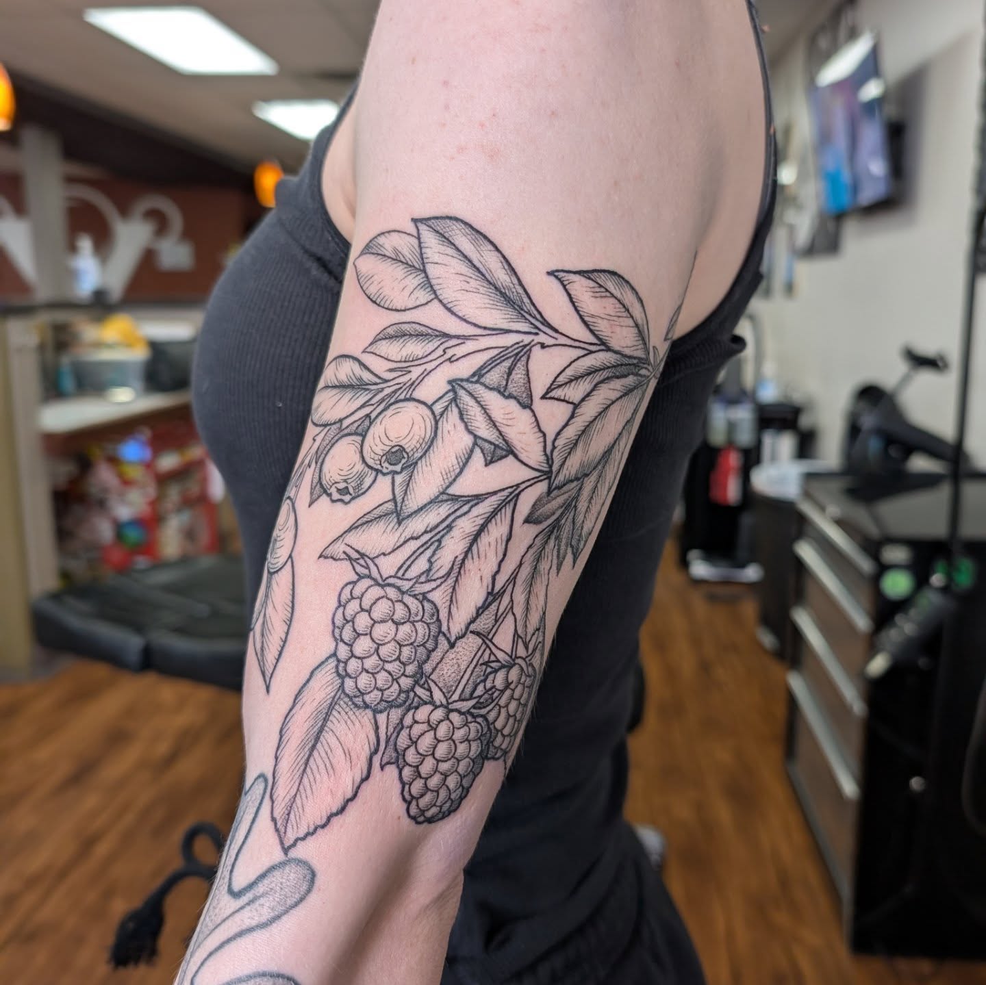 Berry branch black and grey tattoo on the forearm by Will Alexander, Lombard, Illinois