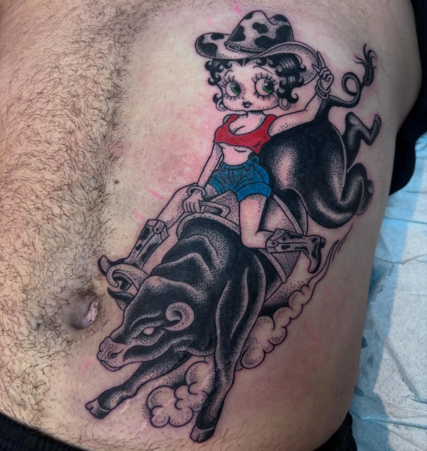 Betty boop riding bull American traditional tattoo on the thigh by ☠︎ ︎𝗘𝗩𝗔 ☠︎︎