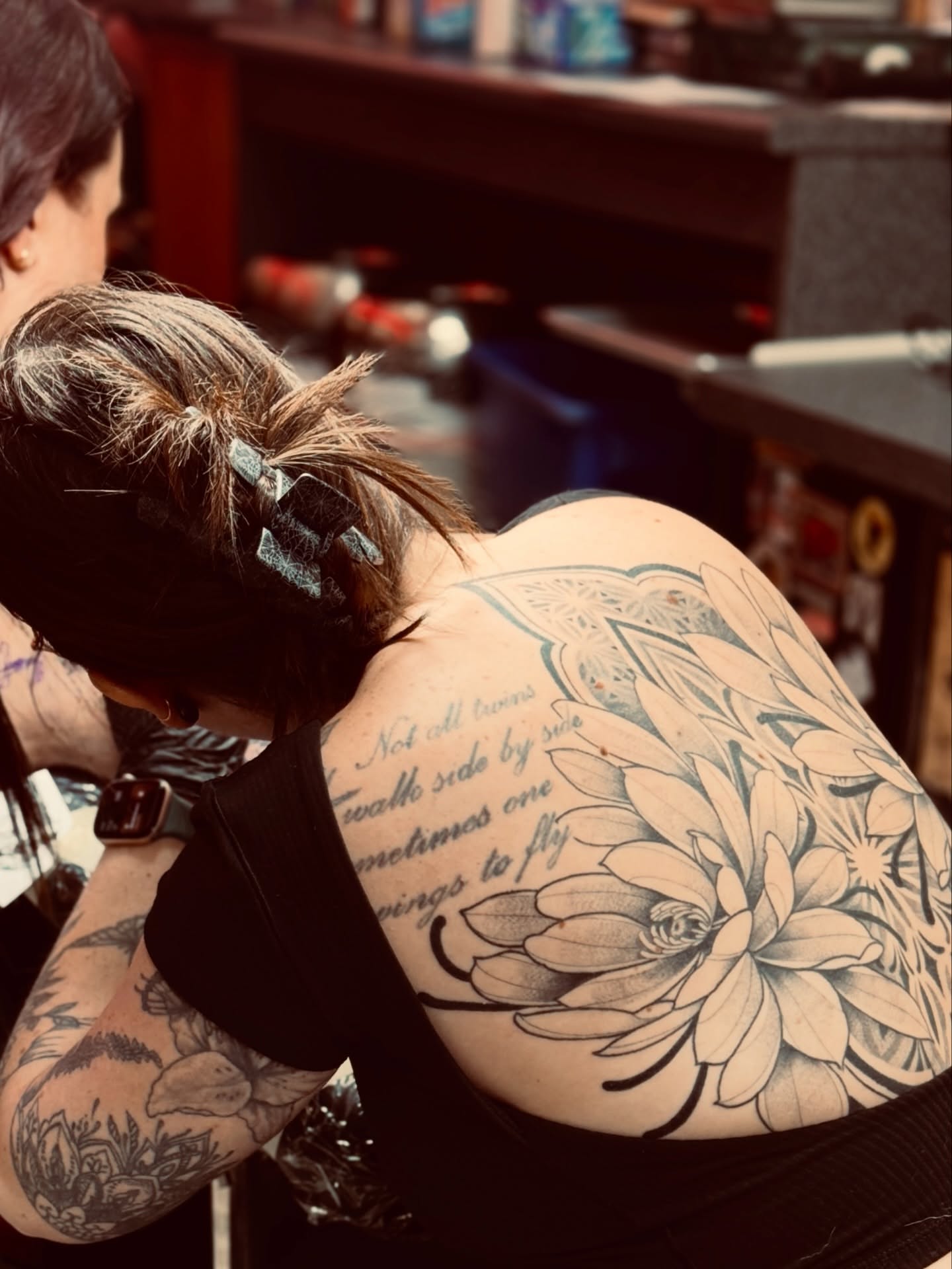 Lotus flower black and grey tattoo on the back by Kylie Allen