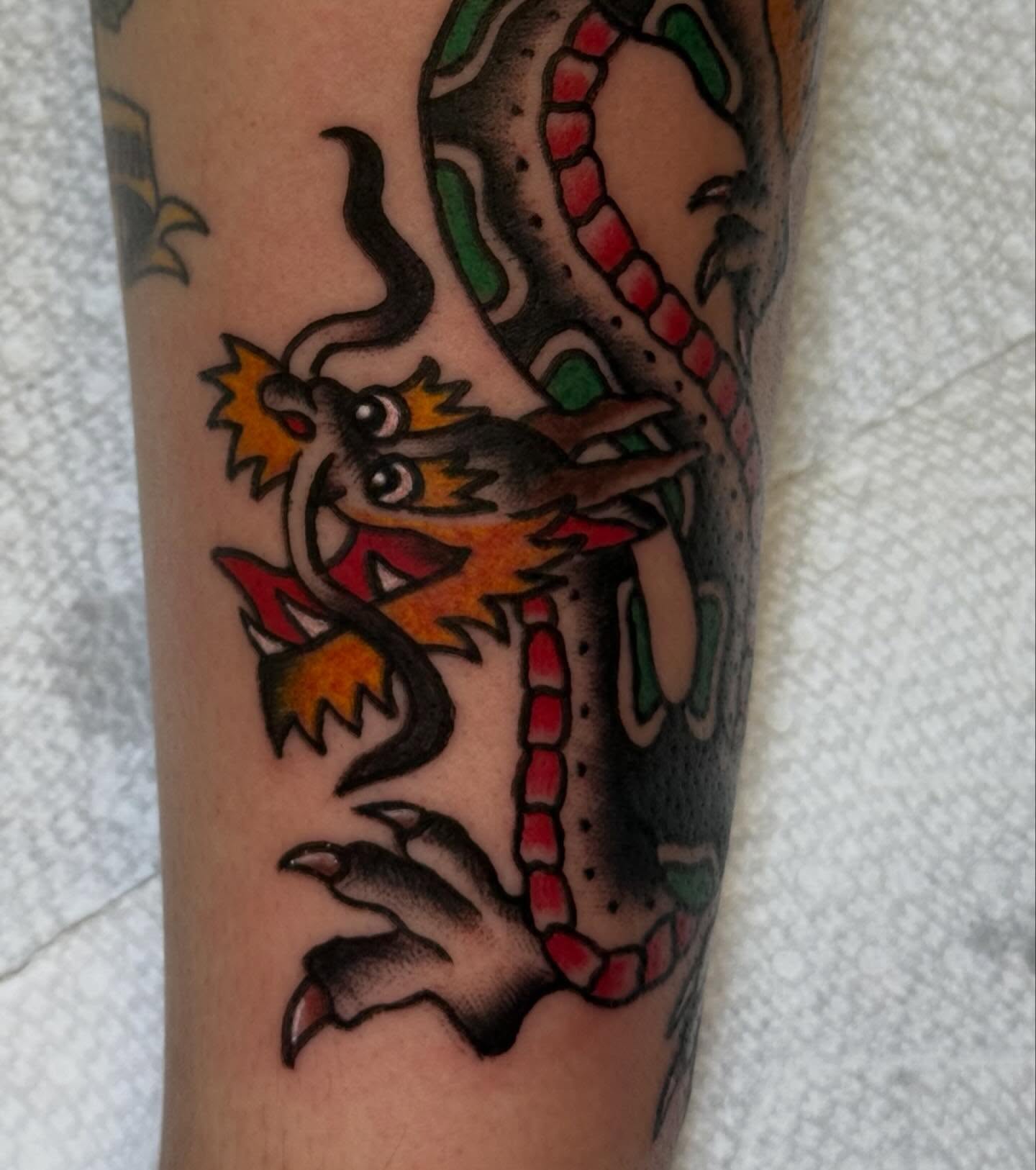 Dragon American traditional tattoo on the forearm by CAT