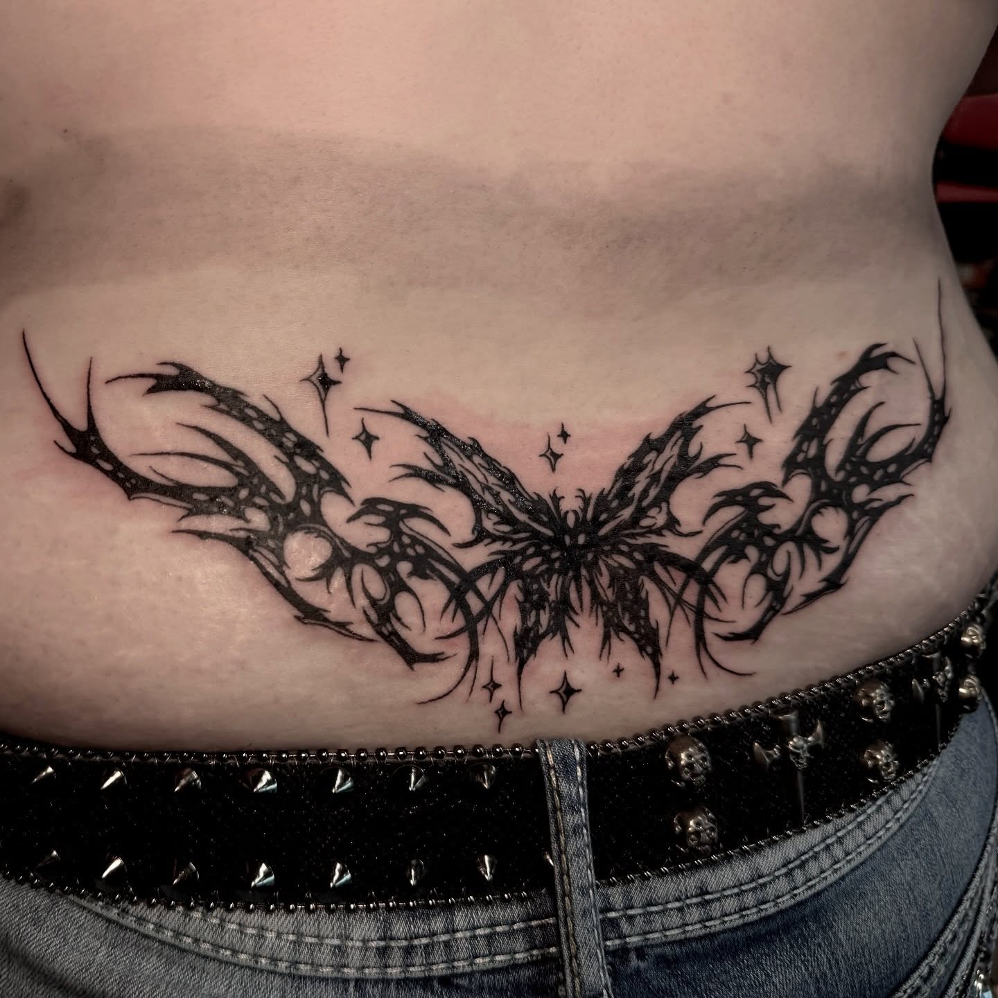 Bat wings tribal tattoo on the torso by Seth Christianson