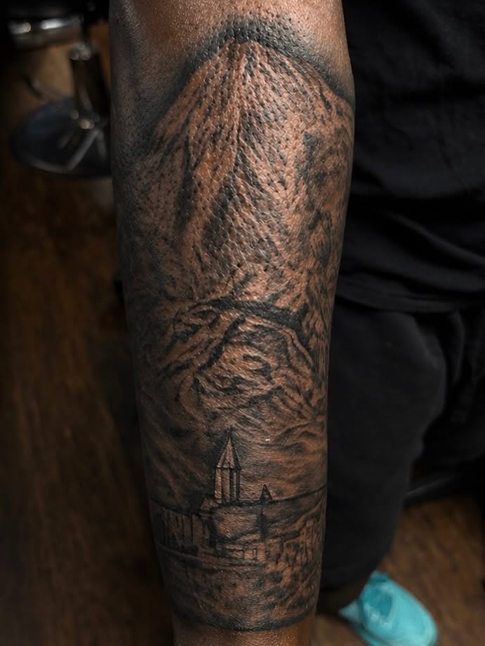 Castle landscape realism tattoo on the forearm by Terik Whittaker