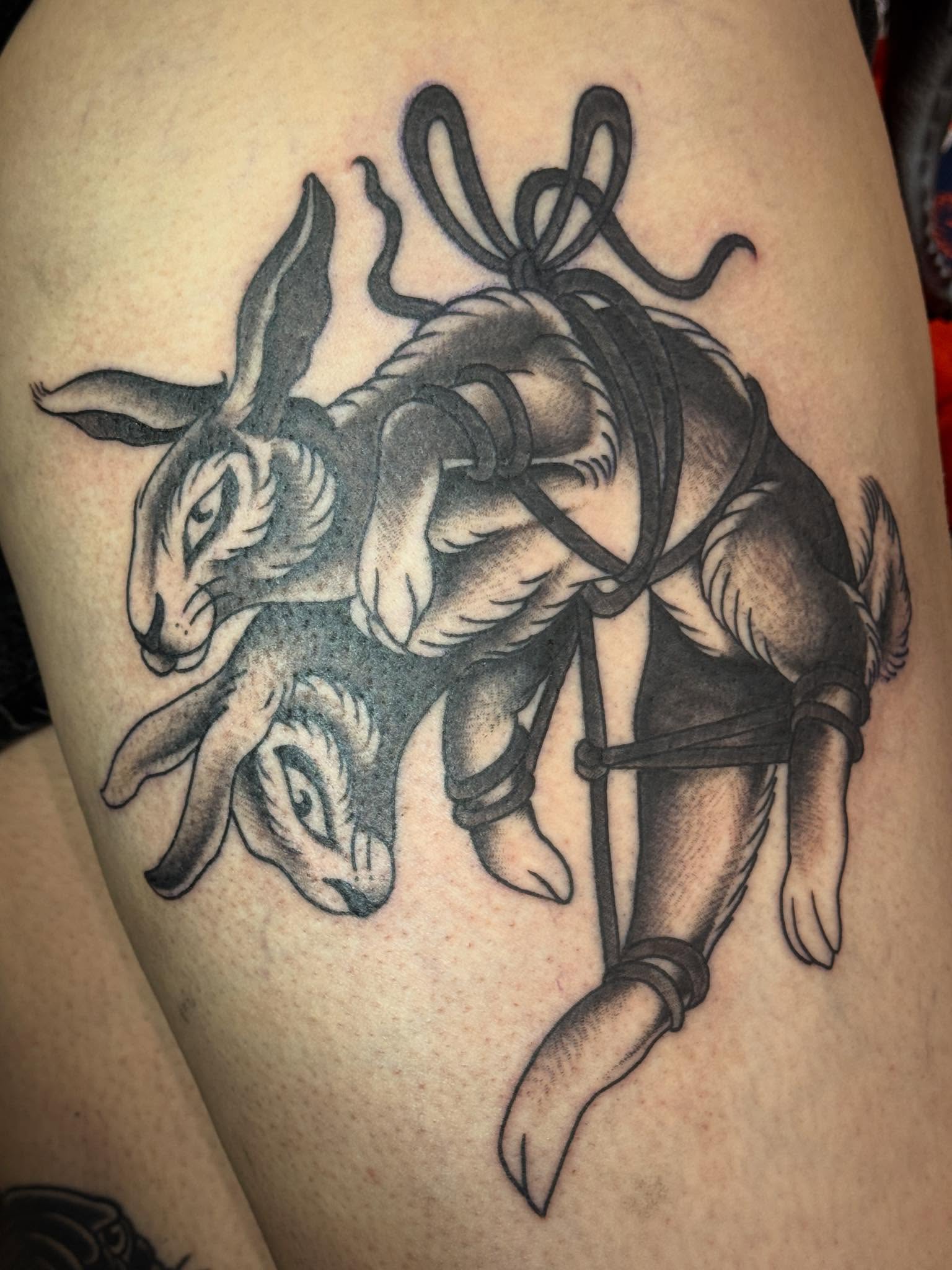 Rabbits black and grey tattoo on the thigh by 🕸curtis Fink🕸