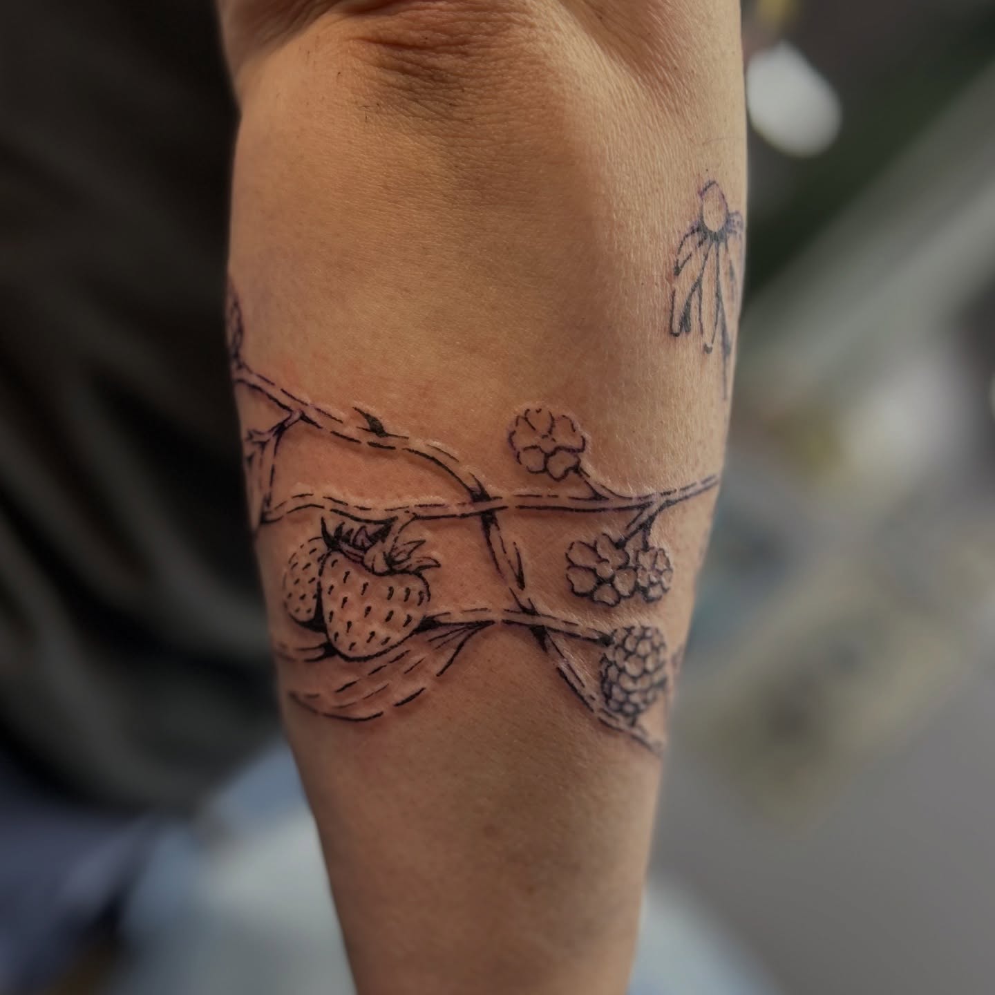 Strawberries and berries black and grey tattoo on the forearm by Natalie Johnson, Minneapolis, Minnesota