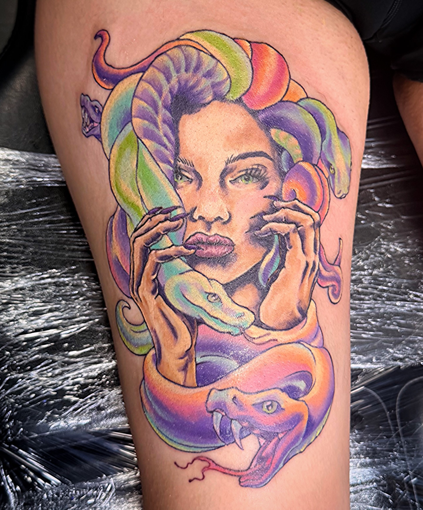 Woman with snakes illustrative tattoo on the thigh by Stephanie Comito-Stephens
