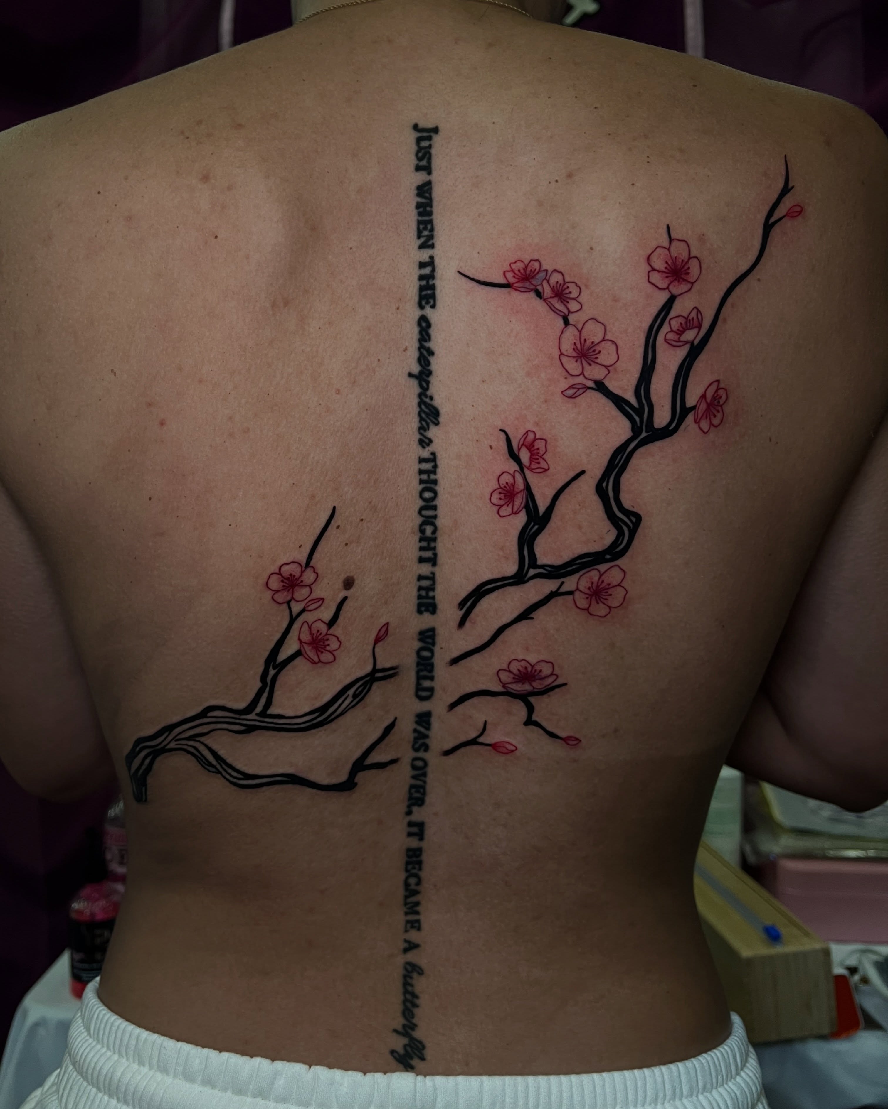 Cherry blossom branches dotwork tattoo on the back by Uncomfy Comfort Tattoos LLC