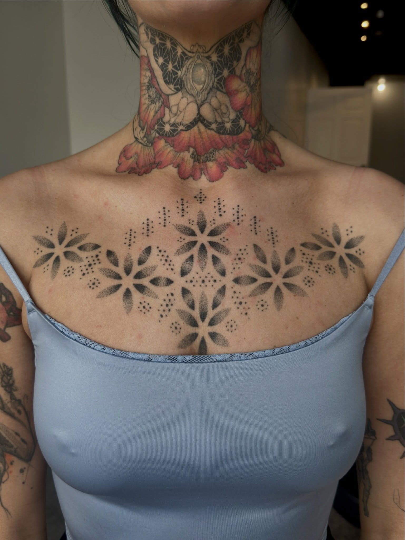 Geometric floral pattern dotwork tattoo on the chest by Chelsey