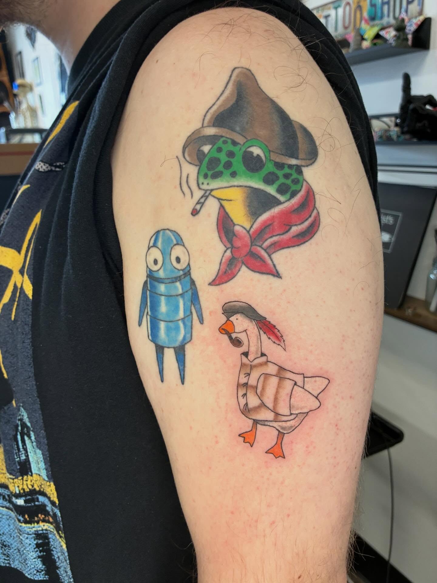 Animal trio American traditional tattoo on the upper arm by Hit & Run Tattoo, Dayton, Ohio