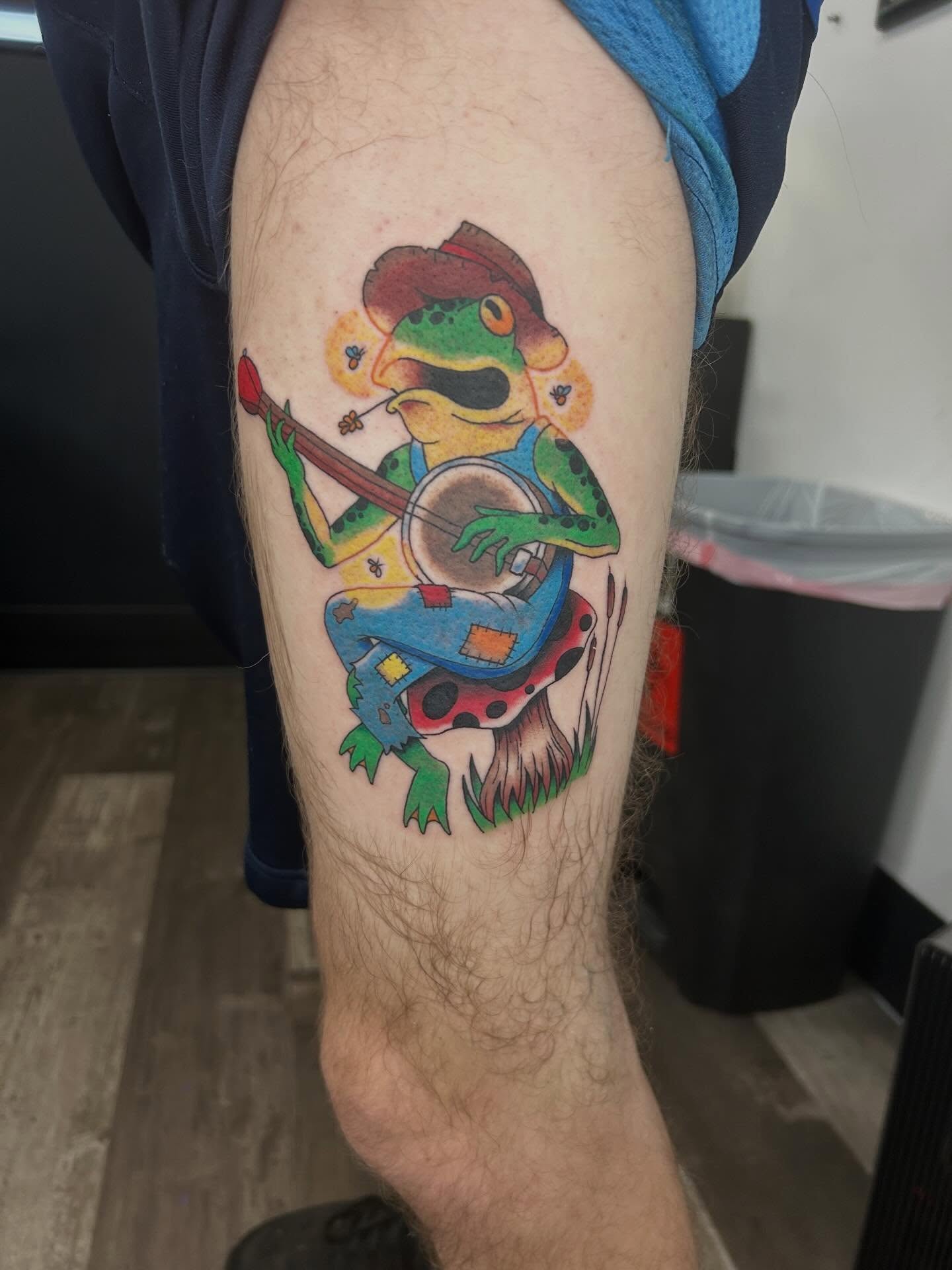 Frog playing banjo new school tattoo on the forearm by Hit & Run Tattoo, Dayton, Ohio