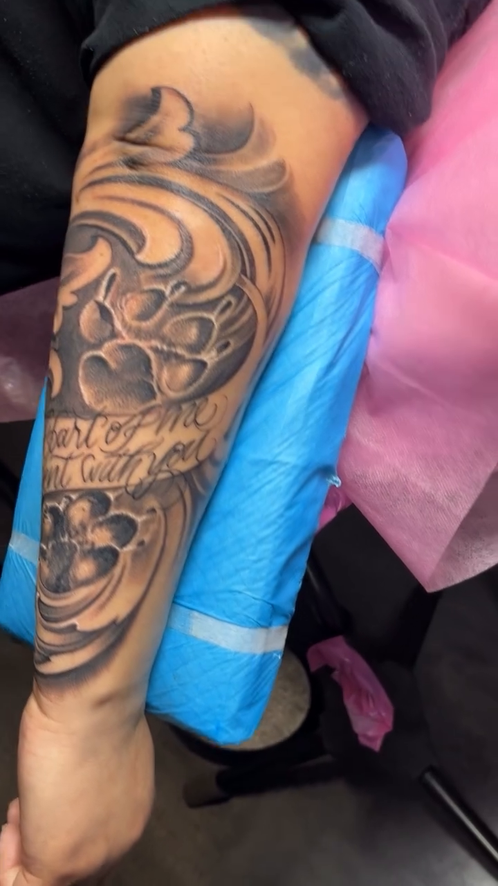 Paw prints and script tattoo Chicano tattoo on the forearm by Yulia Chekir, Chicago, Illinois
