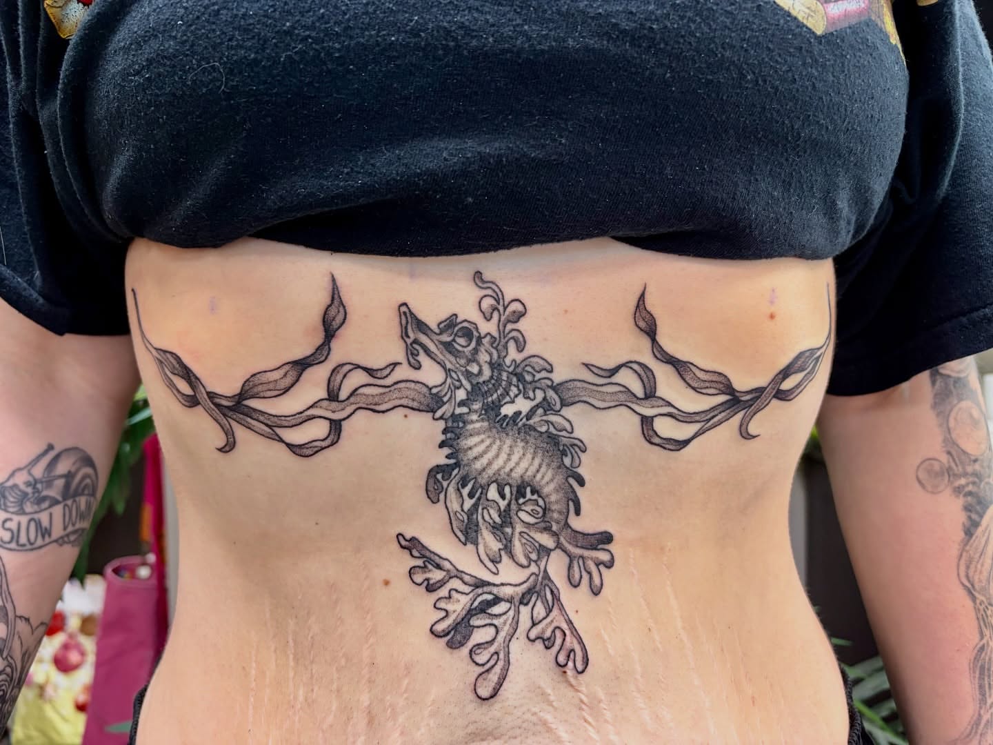 Seahorse and seaweed black and grey tattoo on the ribs by Taylor Heidtbrink
