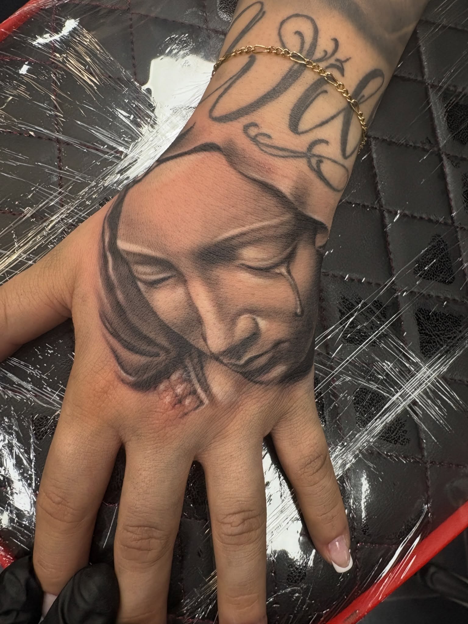 Portrait realism tattoo on the hand by Ben Loredo