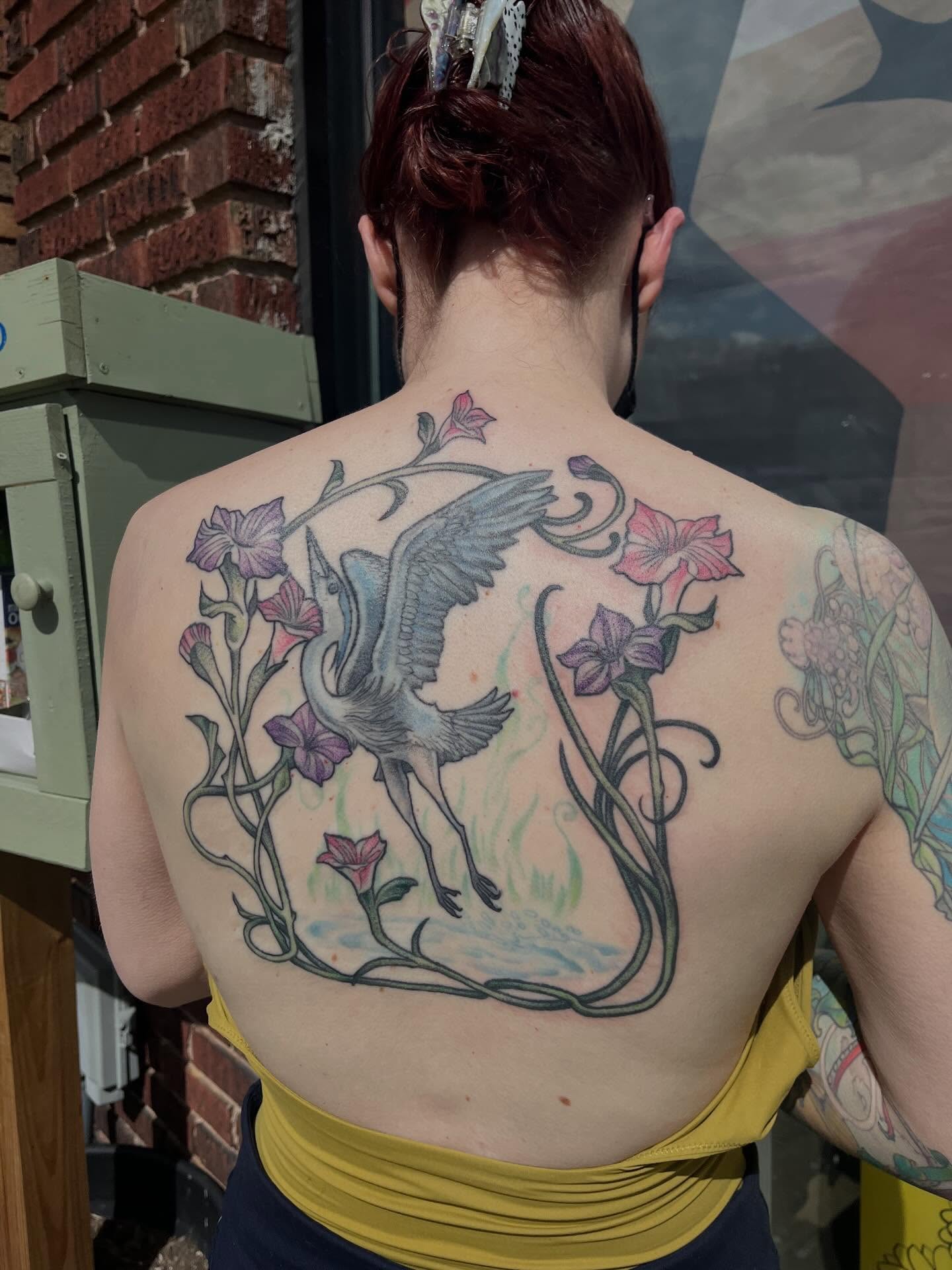 Heron and flowers new school tattoo on the back by bunny, Minneapolis, Minnesota