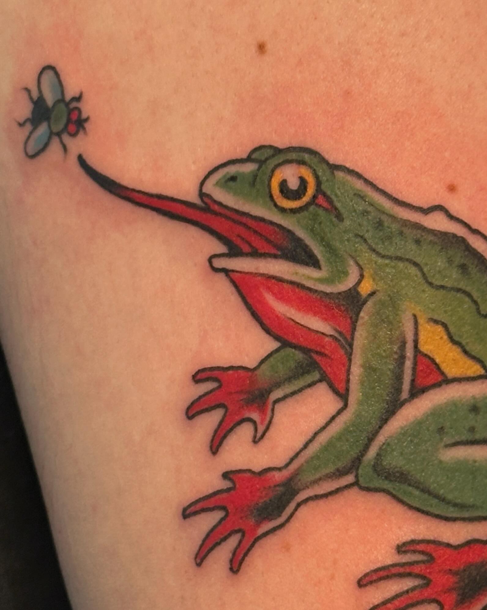 Frog chasing fly American traditional tattoo on the forearm by Craig Ryans