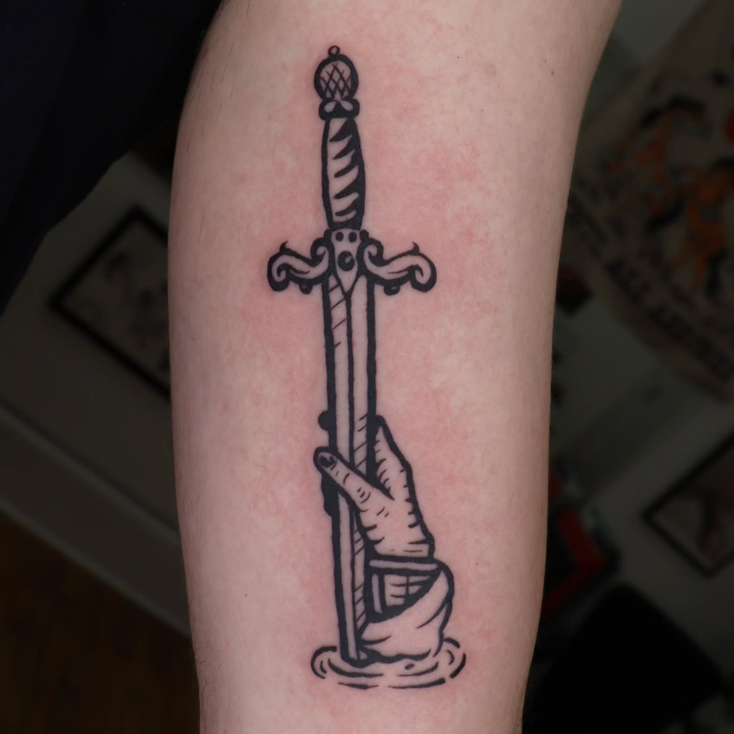 Sword拔出 black and grey tattoo on the forearm by Veronika Lipchak