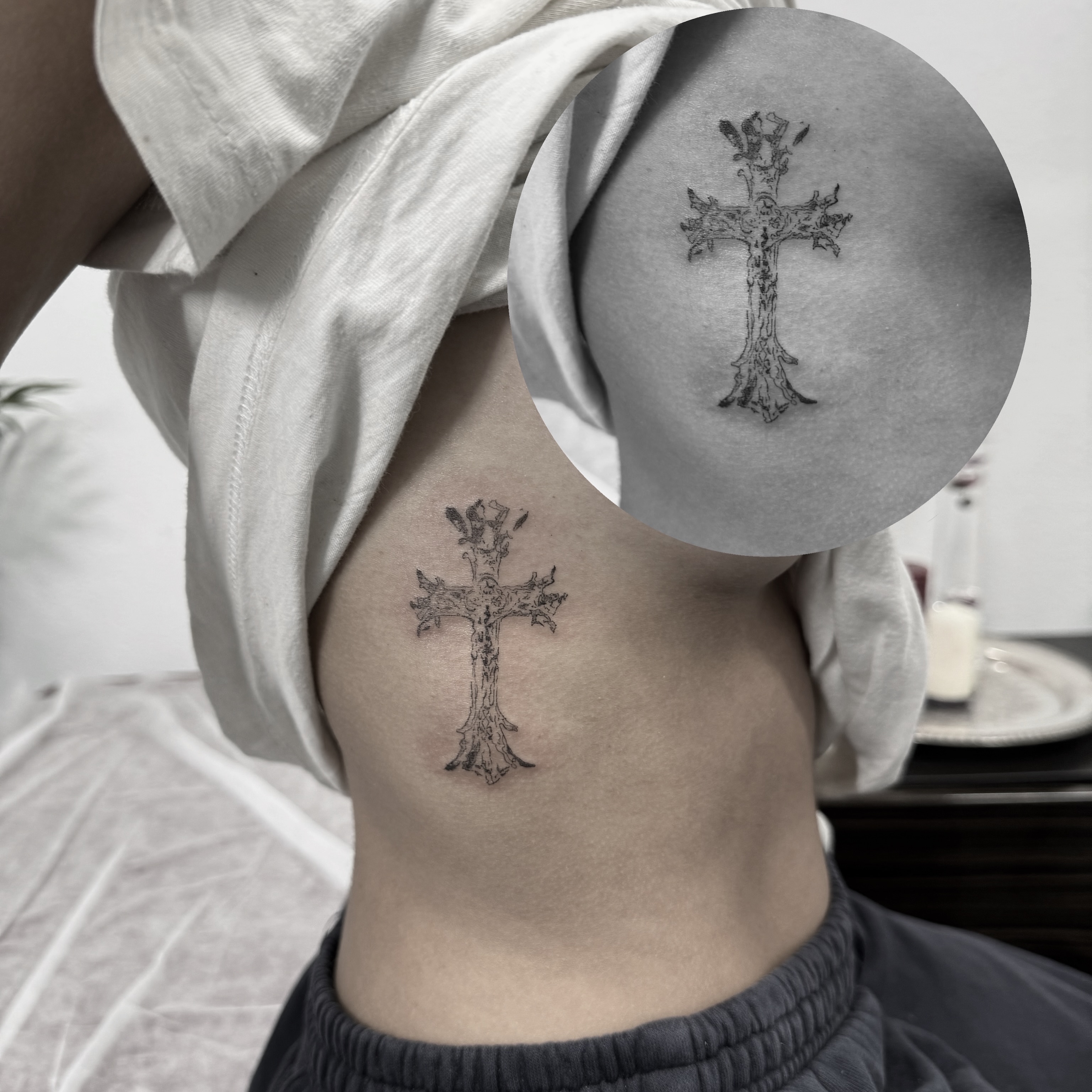 Cross black and grey tattoo on the ribs by Ava De La Torre