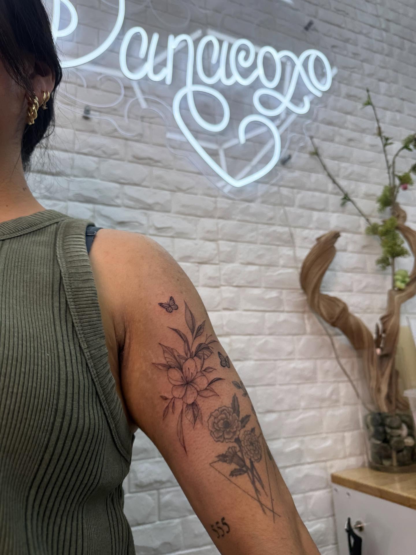 Floral arrangement black and grey tattoo on the forearm by Danae Andino