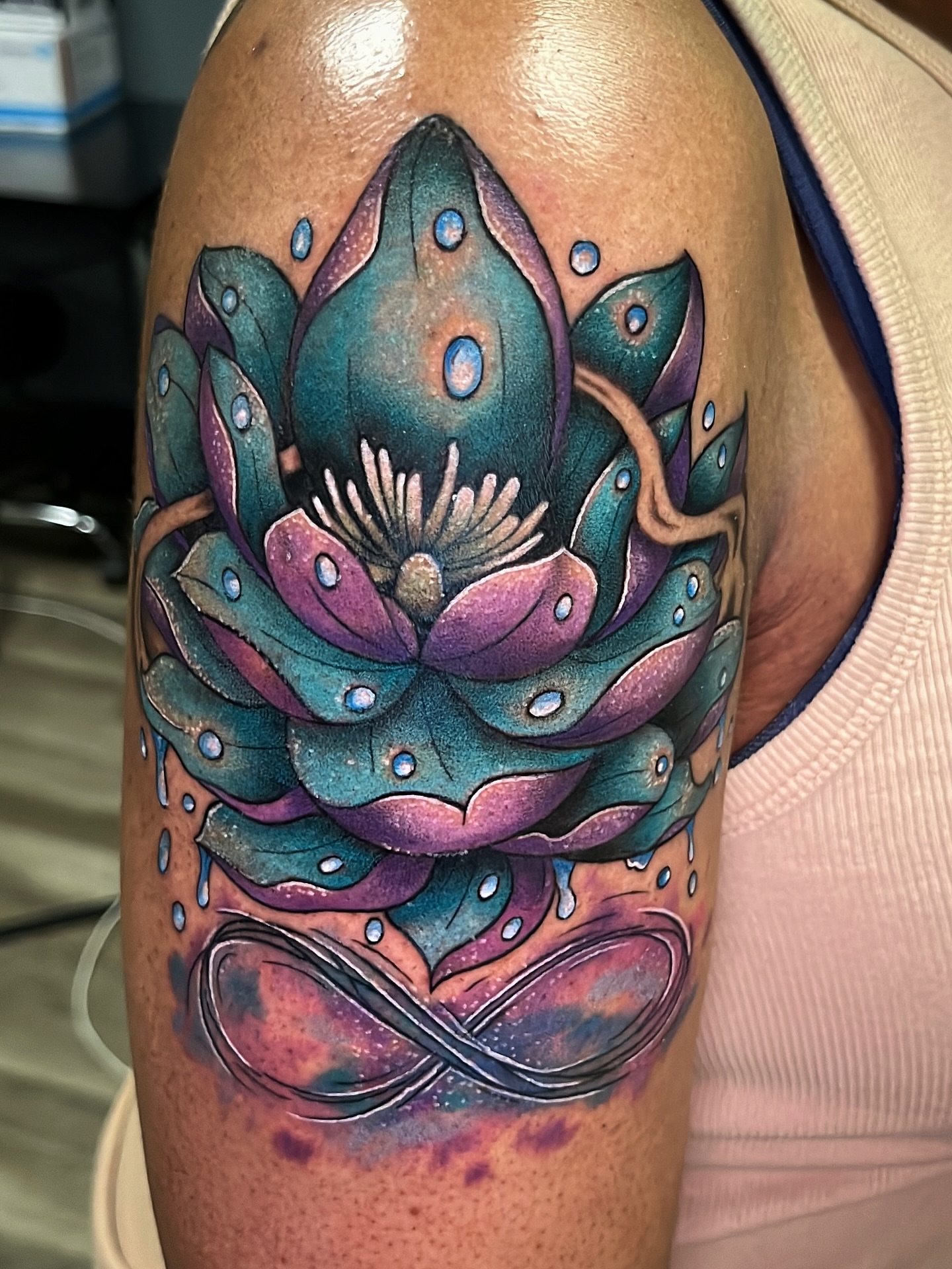 Lotus flower dotwork tattoo on the shoulder by Kyle Schneider