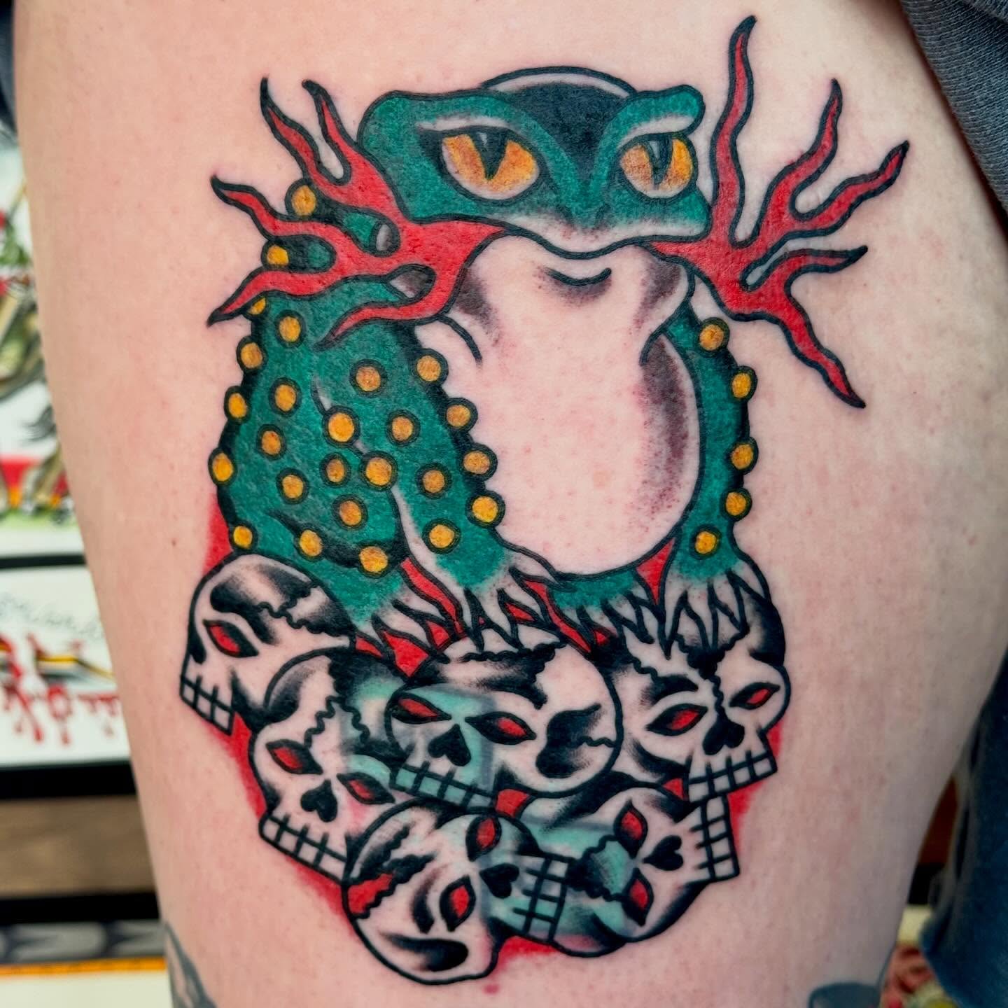 Owl surrounded by skulls American traditional tattoo on the thigh by Eli Bernal