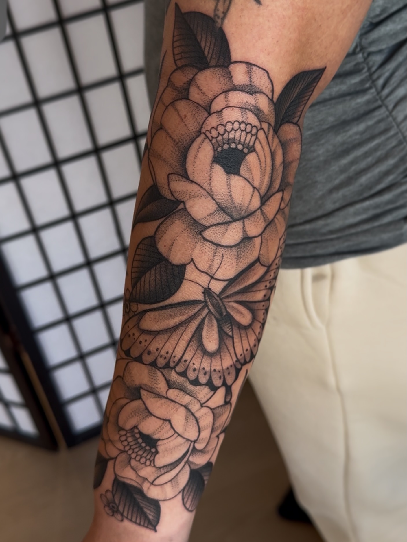 Flower and butterfly dotwork tattoo on the forearm by Kaley, Des Moines, Iowa