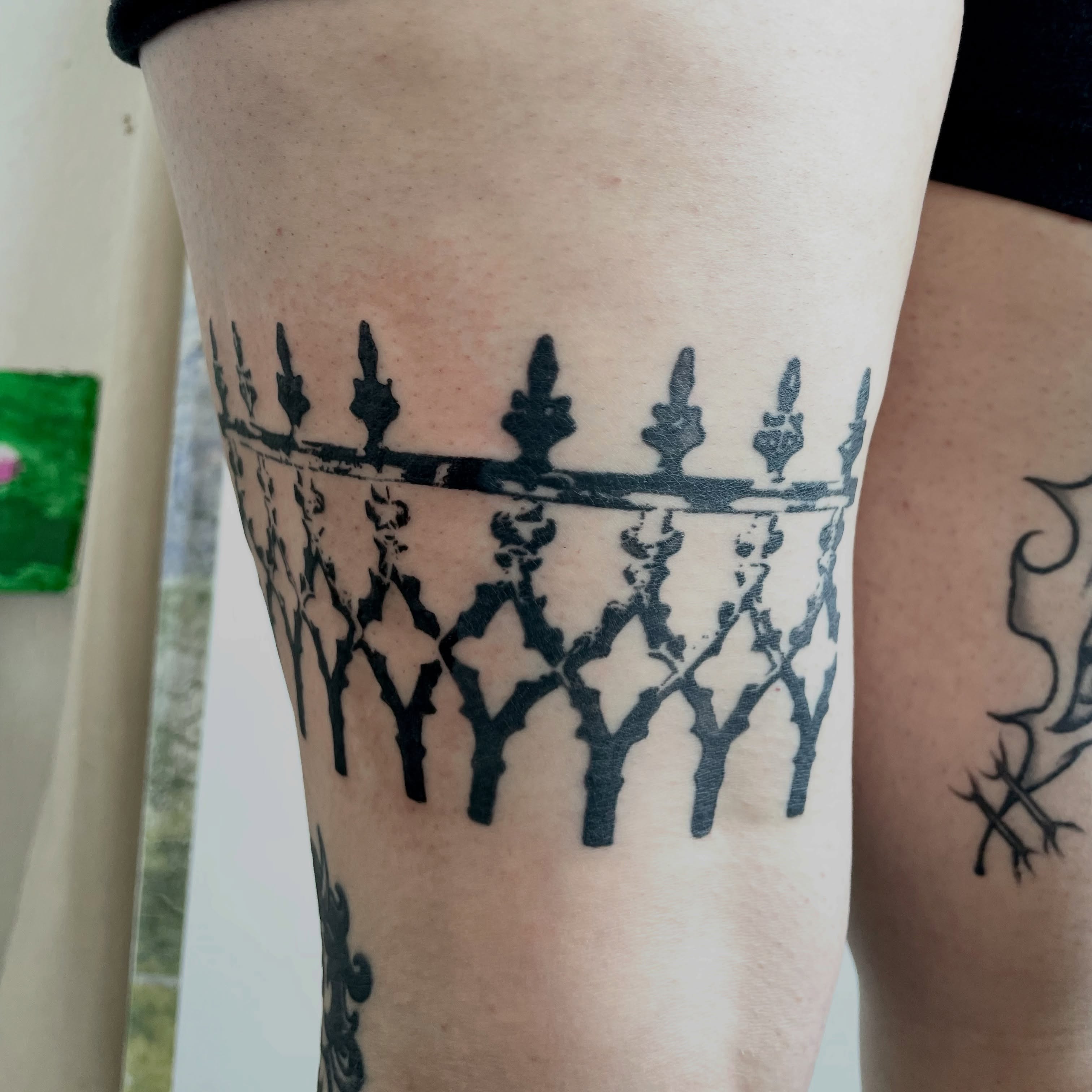 Fence black and grey tattoo on the thigh by bisabuelita