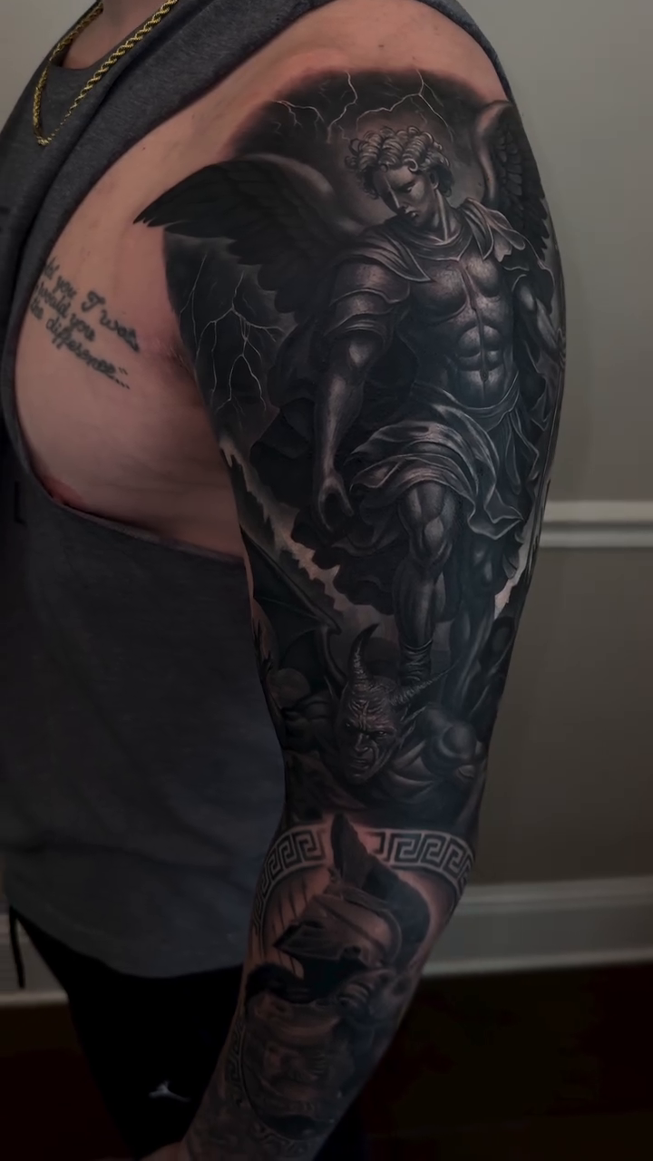 Angel and elephant sleeve realism tattoo on the upper arm by Angels tattoo