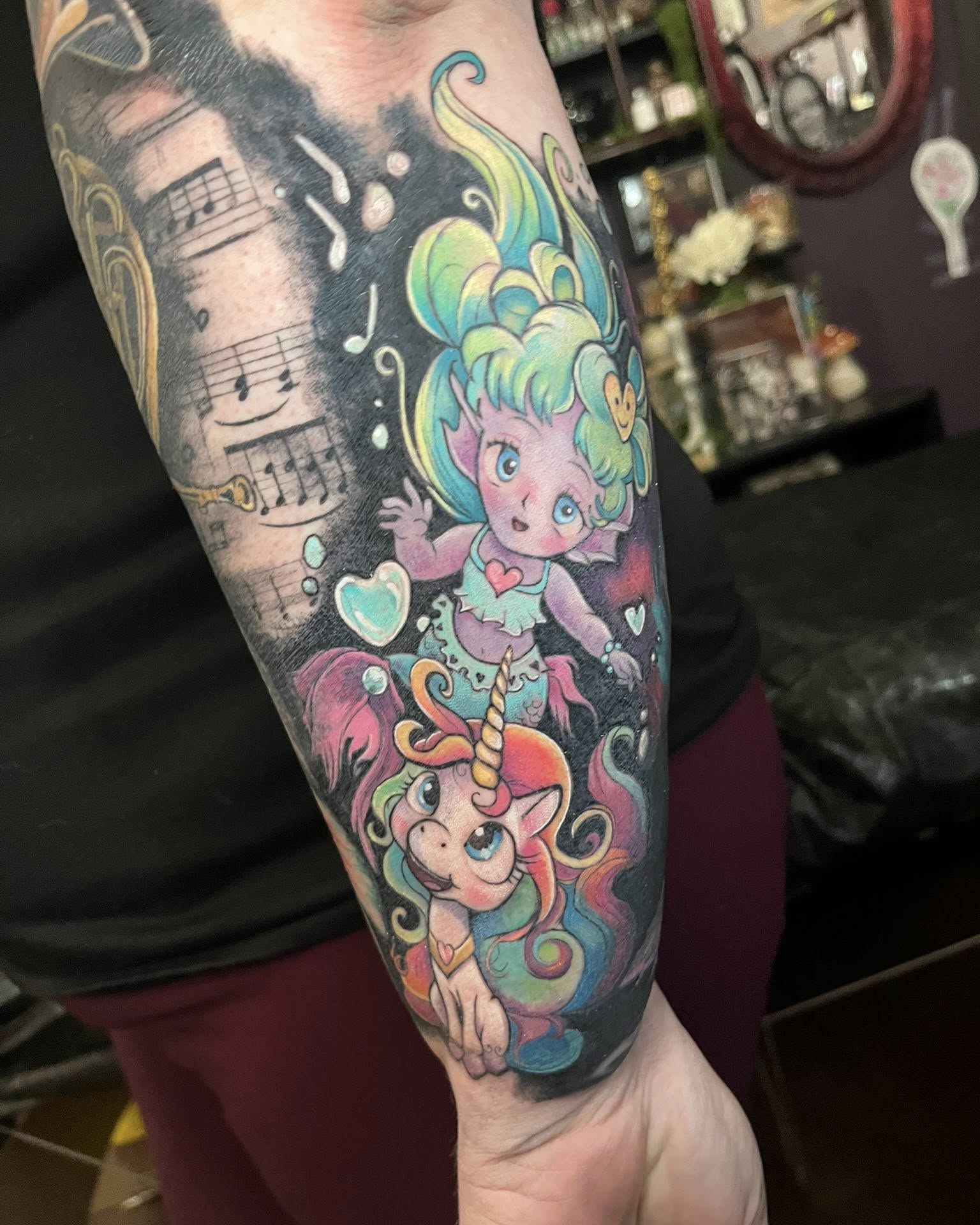 Elf and unicorn new school tattoo on the forearm by SJ