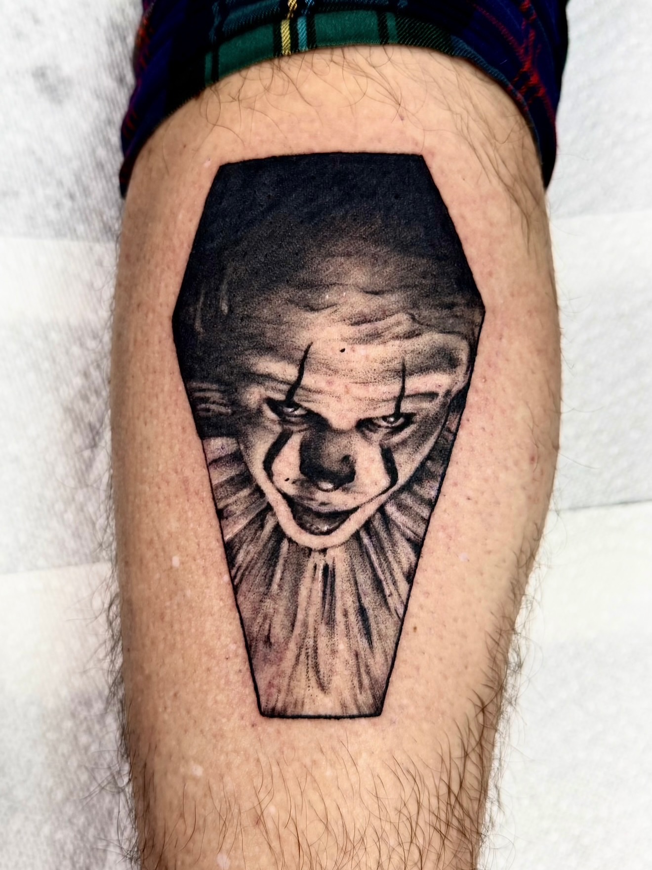 Clown face realism tattoo on the thigh by Josh Kronauer
