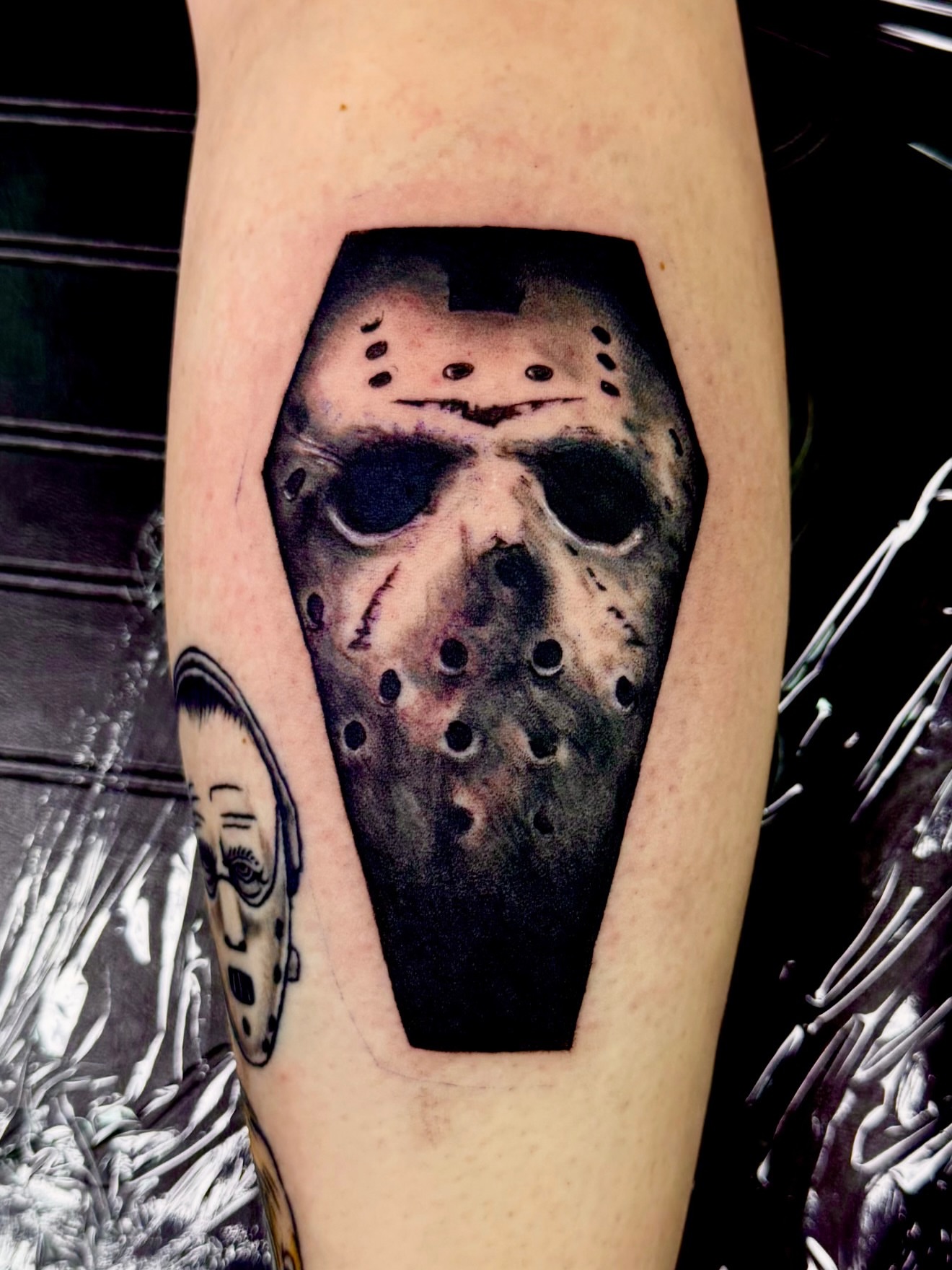 Mask realism tattoo on the forearm by Josh Kronauer