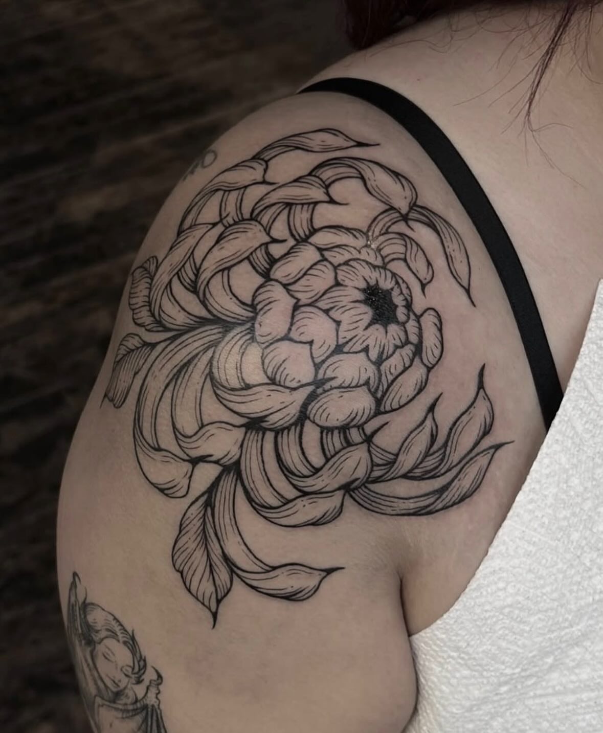 Flower black and grey tattoo on the shoulder by Harlee Hornsby