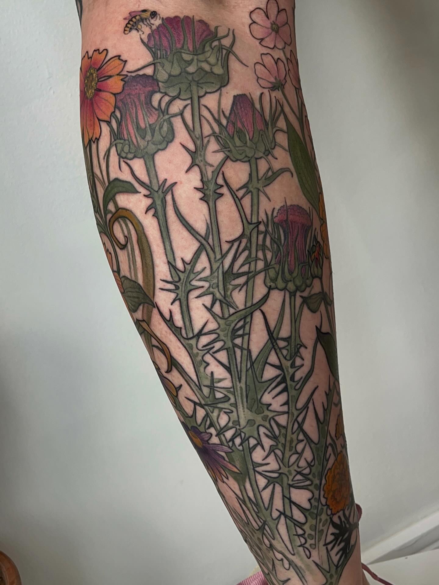 Wildflowers and bee illustrative tattoo on the forearm by Samantha Castrovinci, Durham, North Carolina
