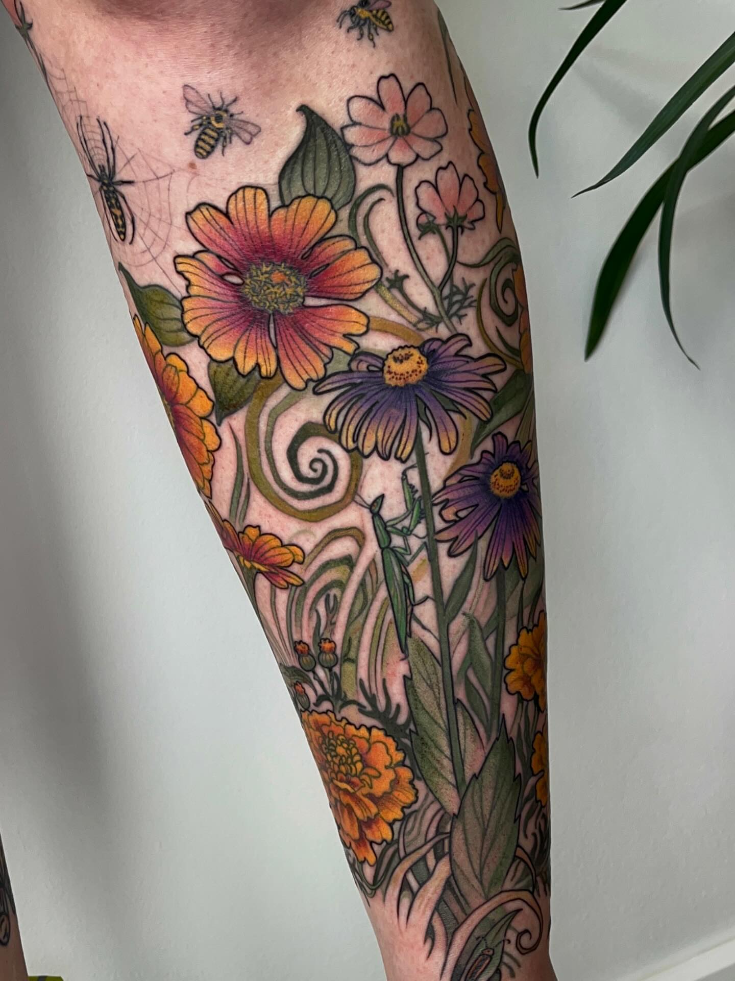 Floral bouquet new school tattoo on the calf by Samantha Castrovinci, Durham, North Carolina